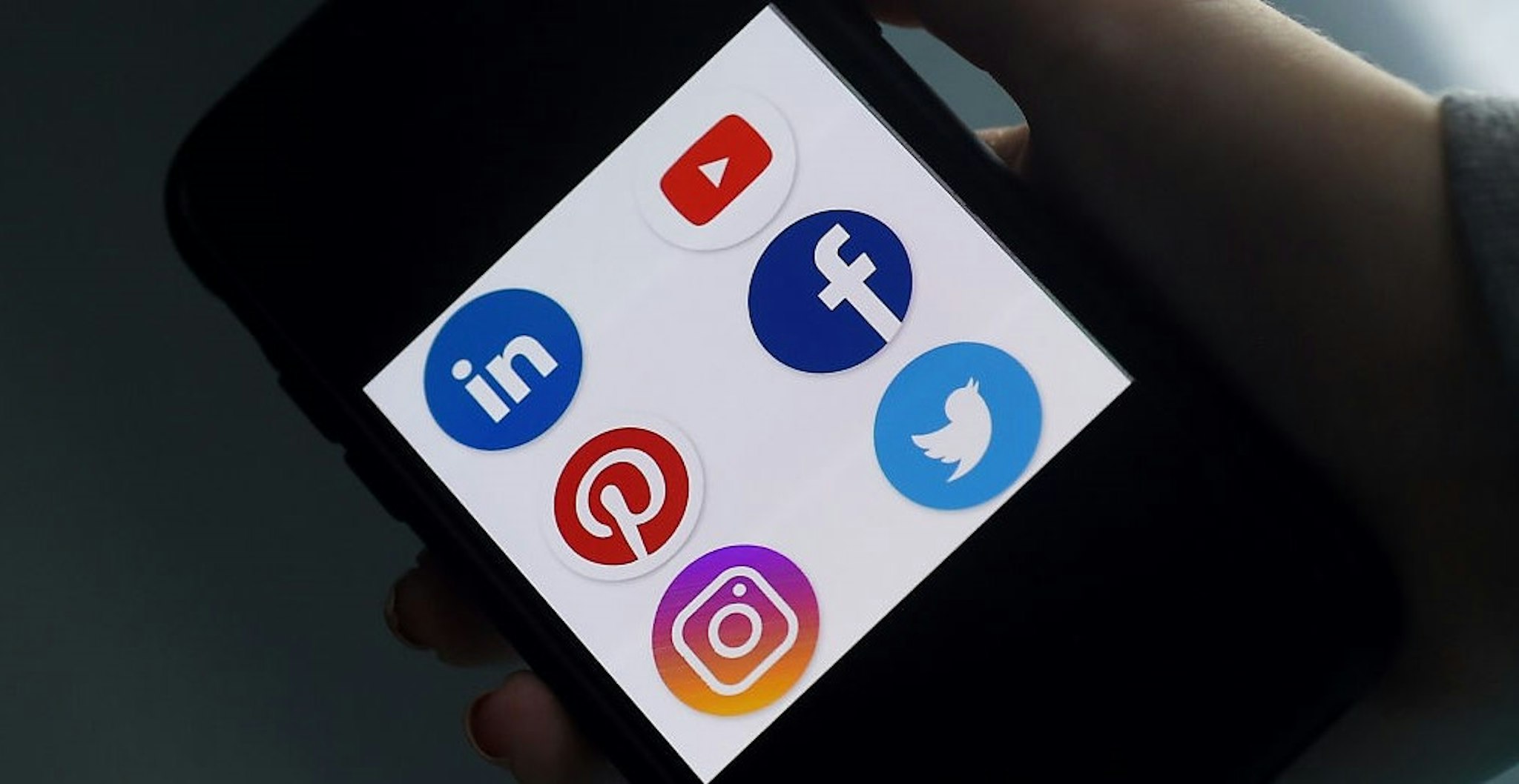This illustration picture shows social media applications logos from Linkedin, YouTube, Pinterest, Facebook, Instagram and Twitter displayed on a smartphone in Arlington, Virginia on May 28, 2020. - Trump is expected to sign an executive order on May 28, 2020, after threatening to shutter social media platforms following Twitter's move to label two of his tweets misleading. (Photo by Olivier DOULIERY / AFP) (Photo by