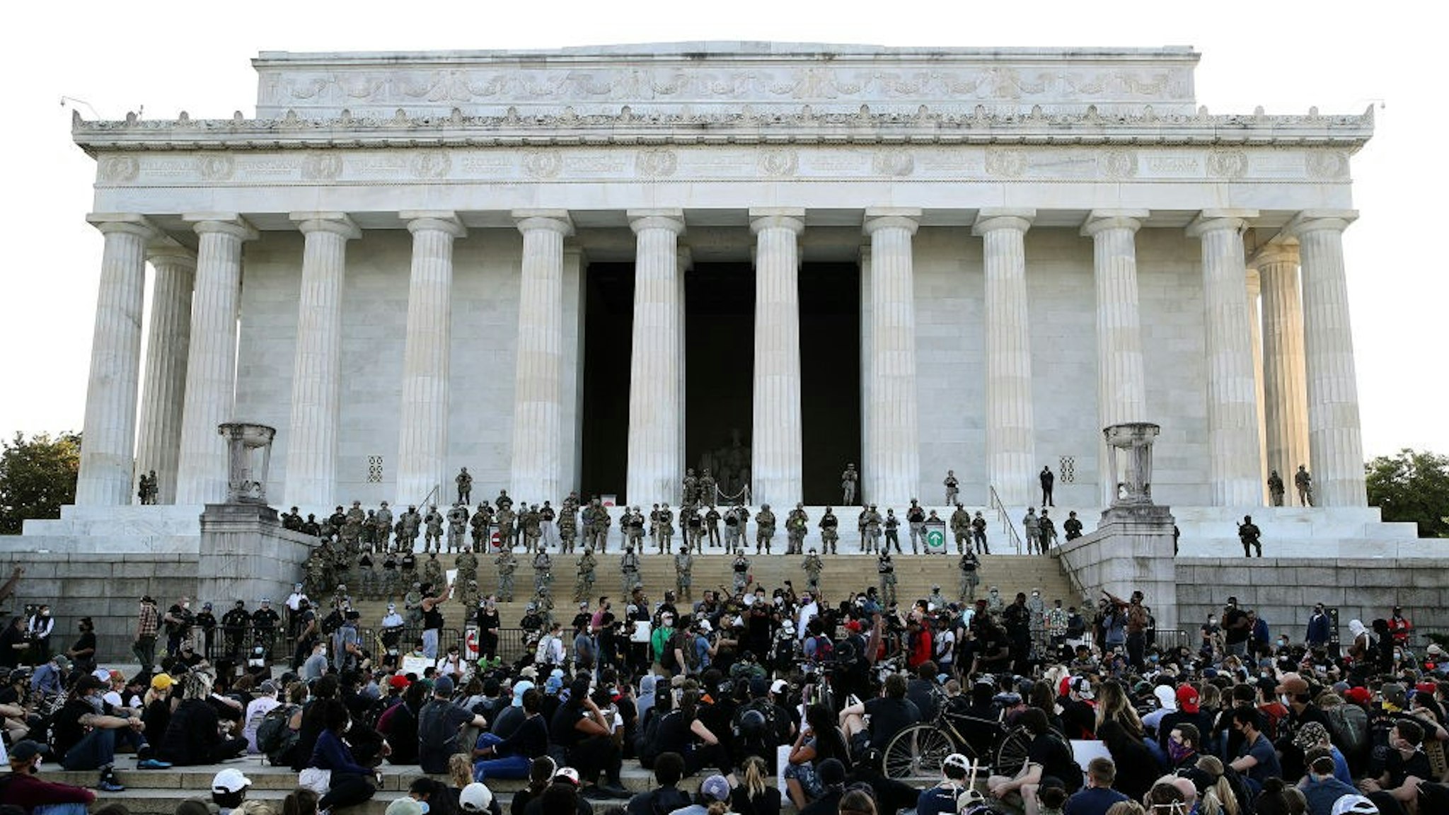 WASHINGTON, DC - JUNE 02: Members of the D.C. National Guard stand on the steps of the Lincoln Memorial monitoring a large crowd of demonstrators participating in a peaceful protest against police brutality and the death of George Floyd, on June 2, 2020 in Washington, DC. Protests continue to be held in cities throughout the country over the death of George Floyd, a black man who was killed in police custody in Minneapolis on May 25. (Photo by
