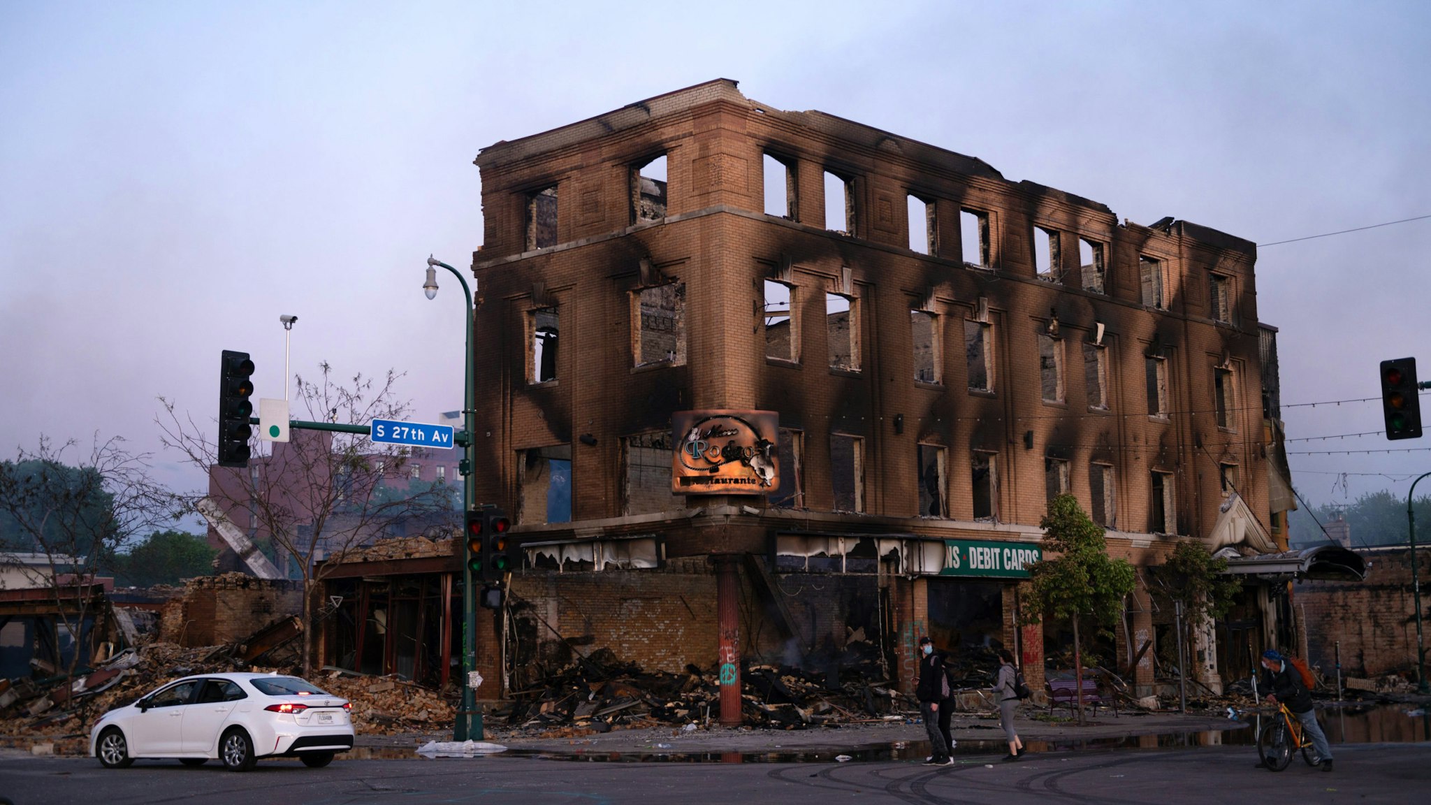 The shell of a building that was burnt during the earlier fires sits still smoldering in Minneapolis, United States, on May 29, 2020. Protests continued following the death of George Floyd, who died after being restrained by Minneapolis police officers on Memorial Day.