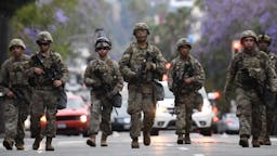 US-POLICE-POLITICS-CRIME-RACE-DEMONSTRATION Armed National Guard soldiers patrol on Hollywood Blvd, June 1, 2020 in Hollywood, California as peaceful protests and looting continue in Los Angeles County. - Major US cities -- convulsed by protests, clashes with police and looting since the death in Minneapolis police custody of George Floyd a week ago -- braced Monday for another night of unrest. More than 40 cities have imposed curfews after consecutive nights of tension that included looting and the trashing of parked cars. (Photo by Robyn Beck / AFP) (Photo by