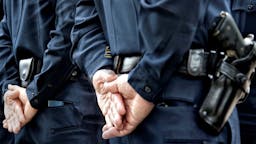 Officers standing with hands behind Officers at Jeremy N. Henwood memorial service in San Diego.
