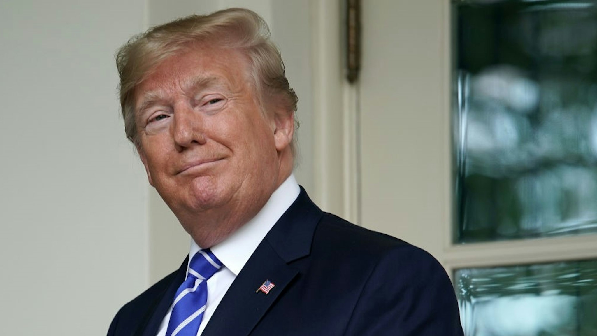 WASHINGTON, DC - JULY 31: U.S. President Donald Trump looks back at journalists after welcoming Mongolian President Battulga Khaltmaa to the White House July 31, 2019 in Washington, DC. Khaltmaa, who traveled to the White House to seek trade and military deals with the United States, also symbolically gifted a horse to Trump's son, Barron. Trump said the horse will be named "Victory." (Photo by