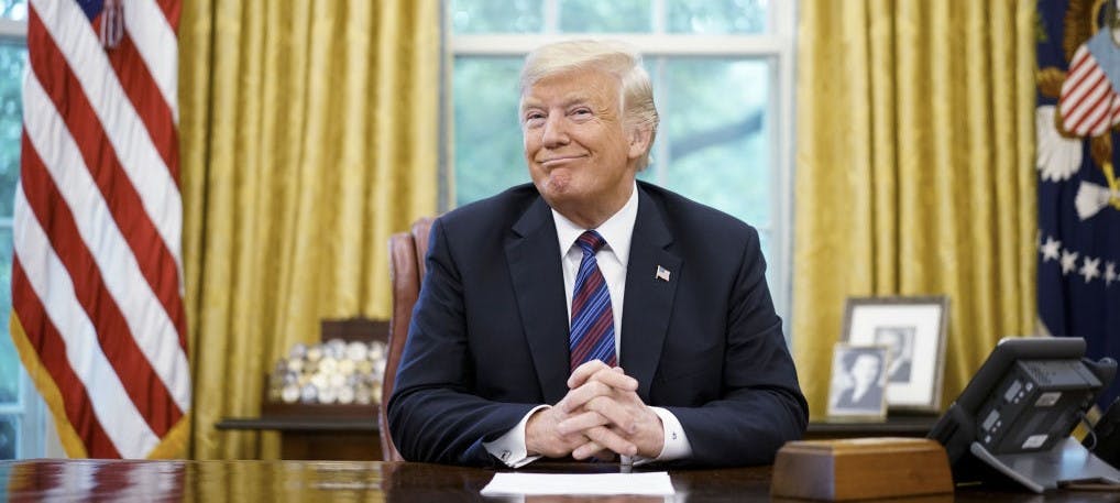 US President Donald Trump smiles during a phone conversation with Mexico's President Enrique Pena Nieto on trade in the Oval Office of the White House in Washington, DC on August 27, 2018. - President Donald Trump said Monday the US had reached a "really good deal" with Mexico and talks with Canada would begin shortly on a new regional free trade pact."It's a big day for trade. It's a really good deal for both countries," Trump said."Canada, we will start negotiations shortly. I'll be calling their prime minister very soon," Trump said.US and Mexican negotiators have been working for weeks to iron out differences in order to revise the nearly 25-year old North American Free Trade Agreement, while Canada was waiting to rejoin the negotiations. (Photo by MANDEL NGAN / AFP) (Photo by