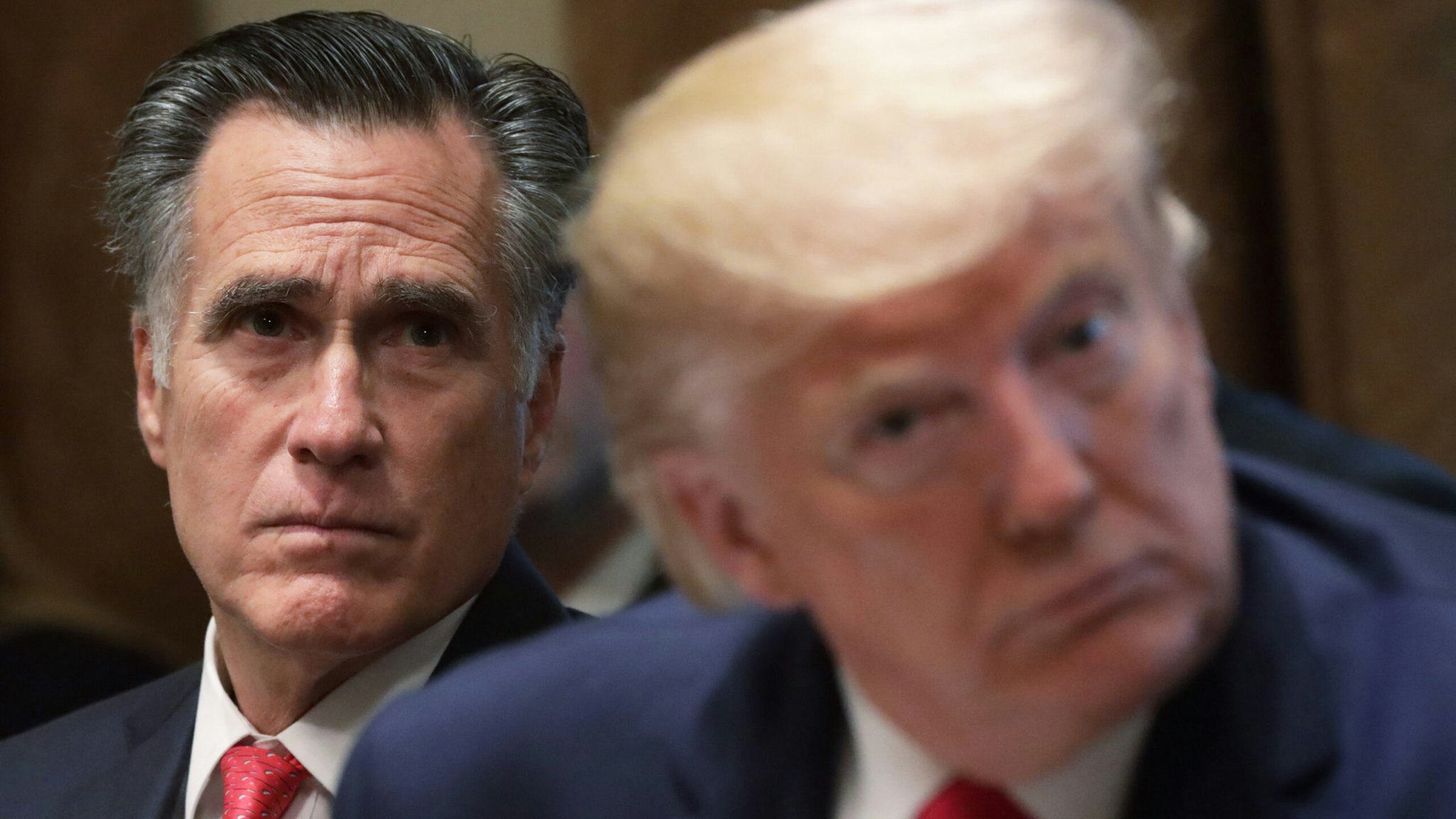 U.S. Sen. Mitt Romney (R-UT) and President Donald Trump listen during a listening session on youth vaping of electronic cigarette on November 22, 2019 in the Cabinet Room of the White House in Washington, DC.