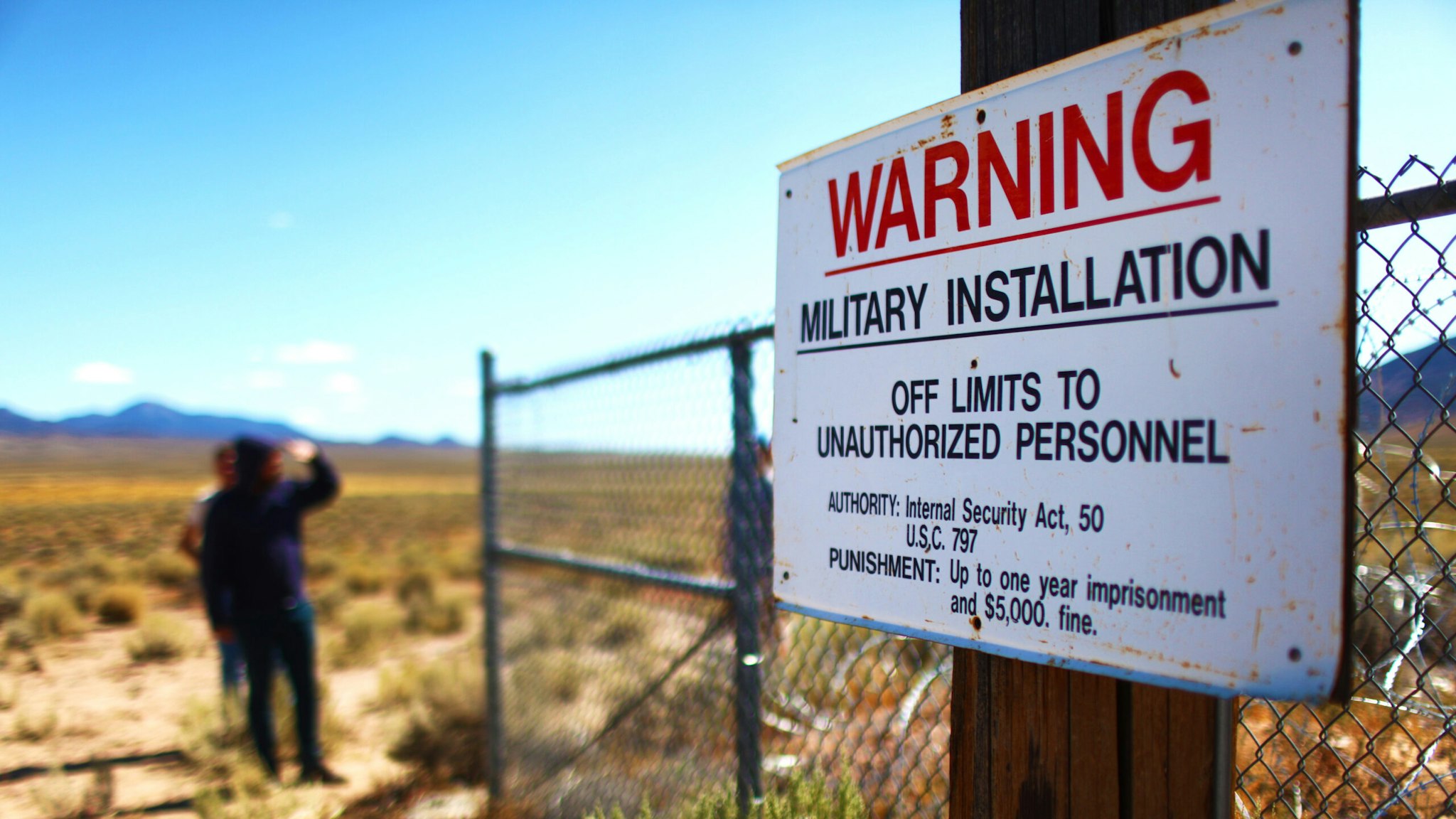 People gather at an entrance gate to the Nevada Test and Training Range, located near Area 51, on September 20, 2019 near Rachel, Nevada. People have gathered at the gate while in town attending 'Storm Area 51' spinoff events. The original Facebook event jokingly encouraged participants to charge the famously secretive Area 51 military base. The military has warned attendees not to approach the protected Area 51 military installation.
