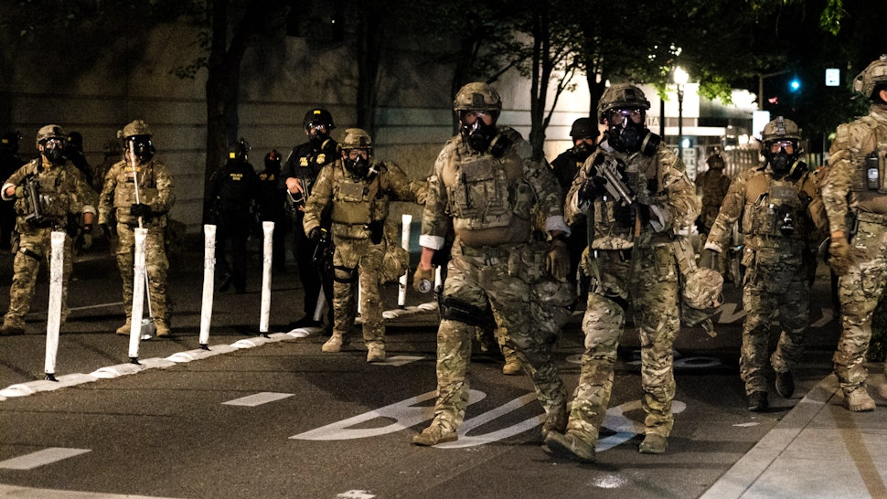 PORTLAND, OR - JULY 17: Federal officers prepare to disperse the crowd of protestors outside the Multnomah County Justice Center on July 17, 2020 in Portland, Oregon. Federal law enforcement agencies attempt to intervene as protests continue in Portland.