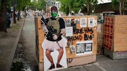 Seattle Announces It Will Phase Down CHOP Autonomous Zone A cutout image of a man holding a firearm, called ANTI-FAiry and created by activists to critique the recent manipulation and misleading use of the mans image by Fox News, is seen at an entrance in the area known as the Capitol Hill Organized Protest (CHOP) on June 24, 2020 in Seattle, Washington. On Monday, Seattle Mayor Jenny Durkan said that the city would phase down the CHOP zone and that the Seattle Police Department would return to its vacated East Precinct. (Photo by David Ryder/Getty Images)