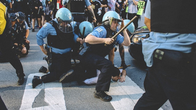 Protesters clash with police in Chicago , on May 30, 2020 during a protest against the death of George Floyd, an unarmed black man who died while while being arrested and pinned to the ground by the knee of a Minneapolis police officer.