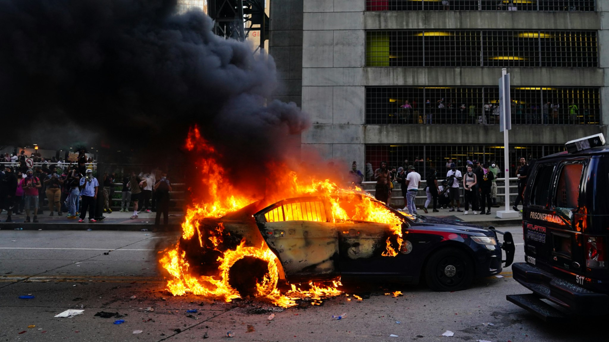 A burning police car is seen during a protest on May 29, 2020 in Atlanta, Georgia. Demonstrations are being held across the US after George Floyd died in police custody on May 25th in Minneapolis, Minnesota.
