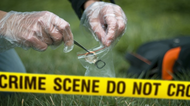 Cropped Hands Collecting Evidence At Crime Scene - stock photo