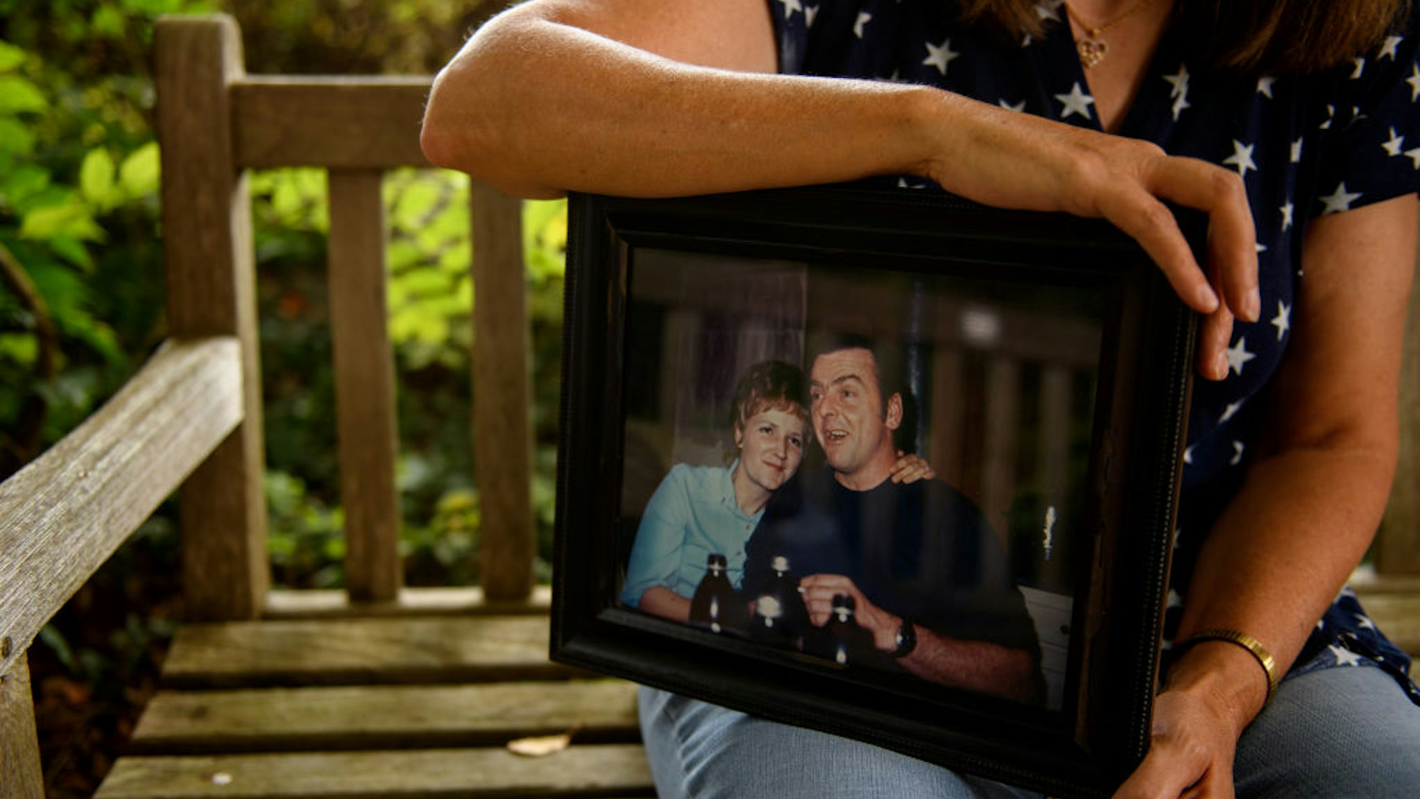 Melanie Proctor with a photo of her mother and father, Army veteran Felix Kirk McDermott, outside the VA Hospital in Clarksburg, West Virginia on September 13, 2019.