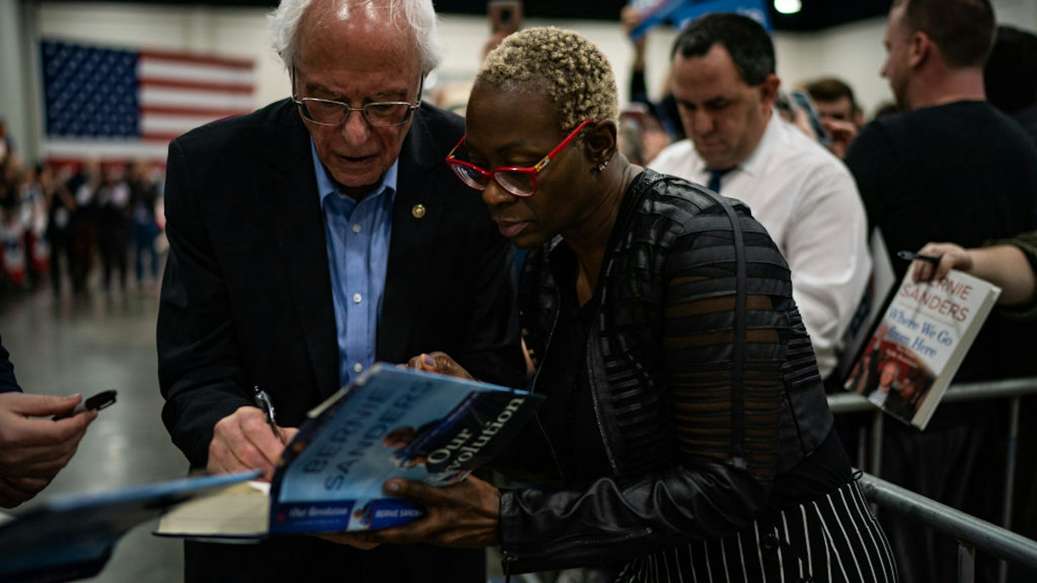 Former Ohio state Sen. Nina Turner holds a book for Sen. Bernie Sanders, I-Vt., 2020 Democratic Presidential Candidate to sign after speaking during a rally at the Myrtle Beach Convention Center on Wednesday, February 26, 2020 in Myrtle Beach, SC.