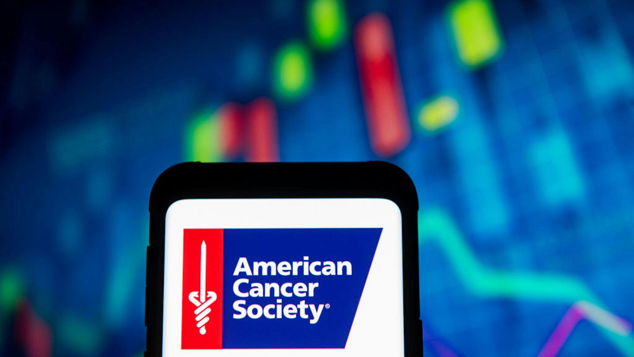 photo illustration an American Cancer Society logo seen displayed on a smartphone.