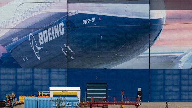 A worker walks outside of a Boeing Co. facility in Everett, Washington, U.S., on Wednesday, May 27, 2020.
