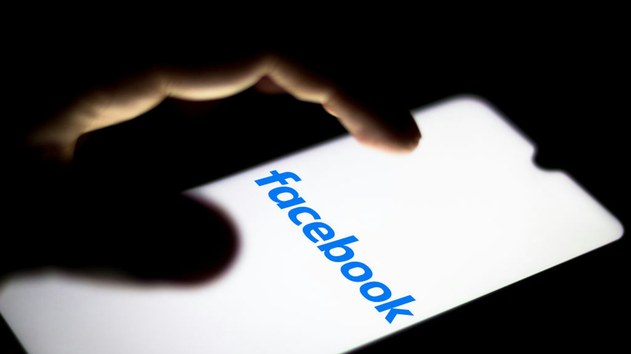 In this photo illustration the Facebook logo seen displayed on a smartphone.