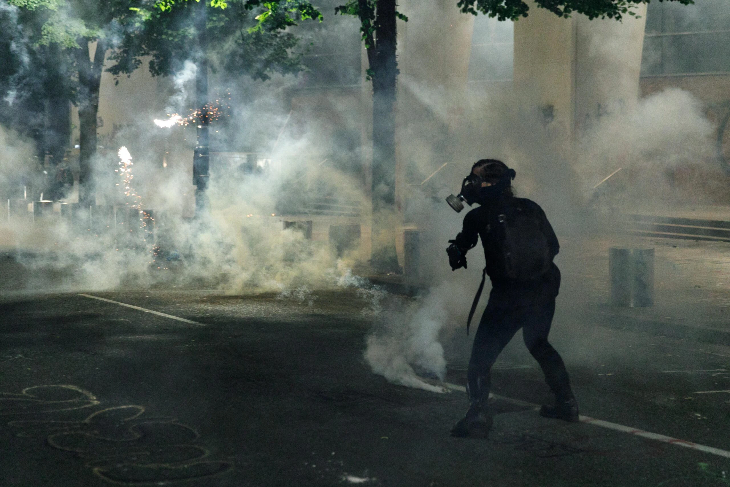 PORTLAND, OREGON, USA: Tear gas and fireworks mix as Black Lives Matter supporters demonstrate in Portland, Oregon on July 4, 2020 for the thirty-eighth day in a row at Portland's Justice Center and throughout Portland, with a riot declared about 12.20 am on July 5. CS tear gas and less-lethal weapons were used, and multiple arrests were made. (Photo by John Rudoff/Anadolu Agency via Getty Images)