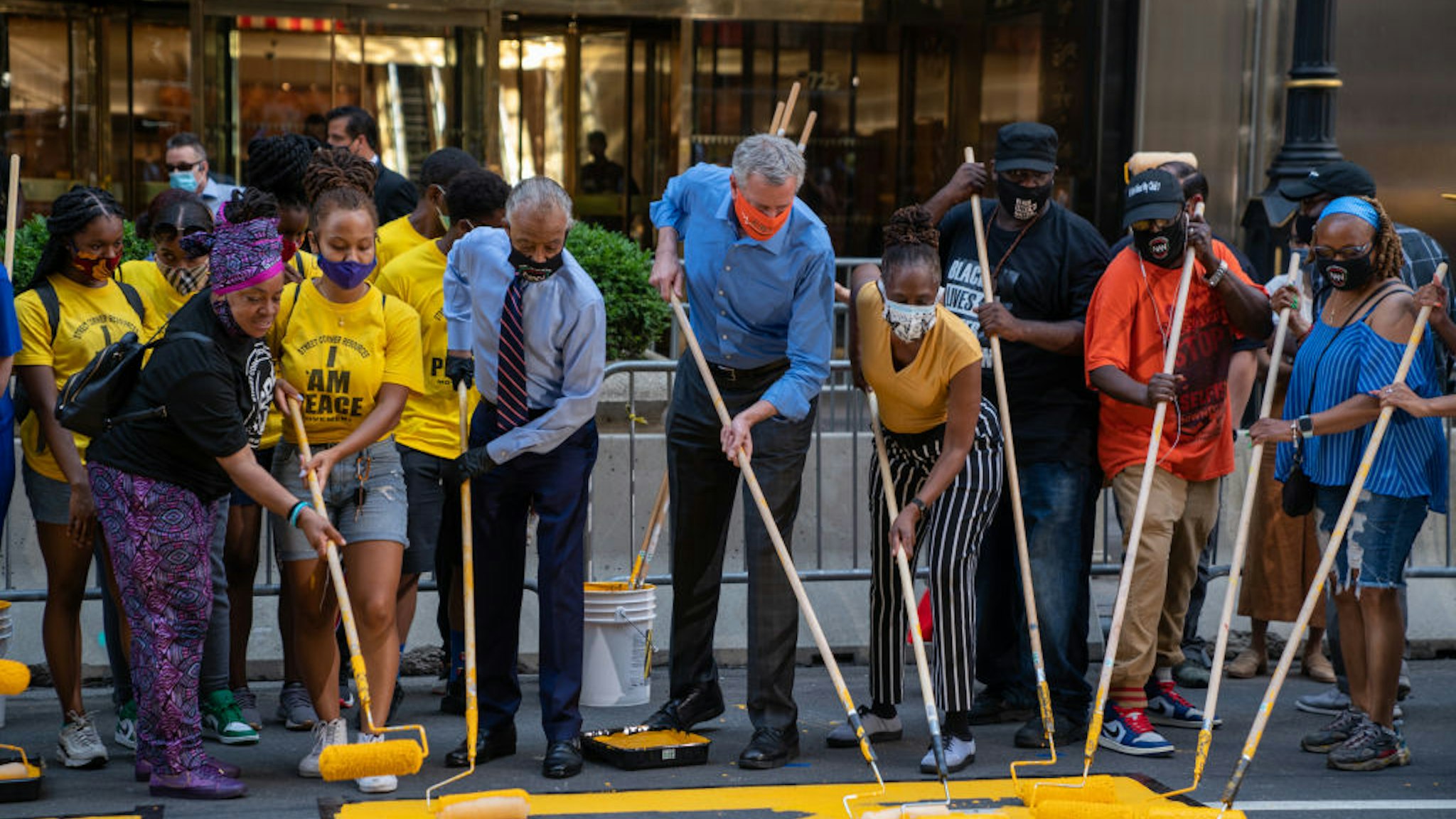 New York City Mayor Bill de Blasio, his wife Chirlane McCray and Rev. Al Sharpton help paint a Black Lives Matter mural on Fifth Avenue directly in front of Trump Tower on July 9, 2020 in New York City.