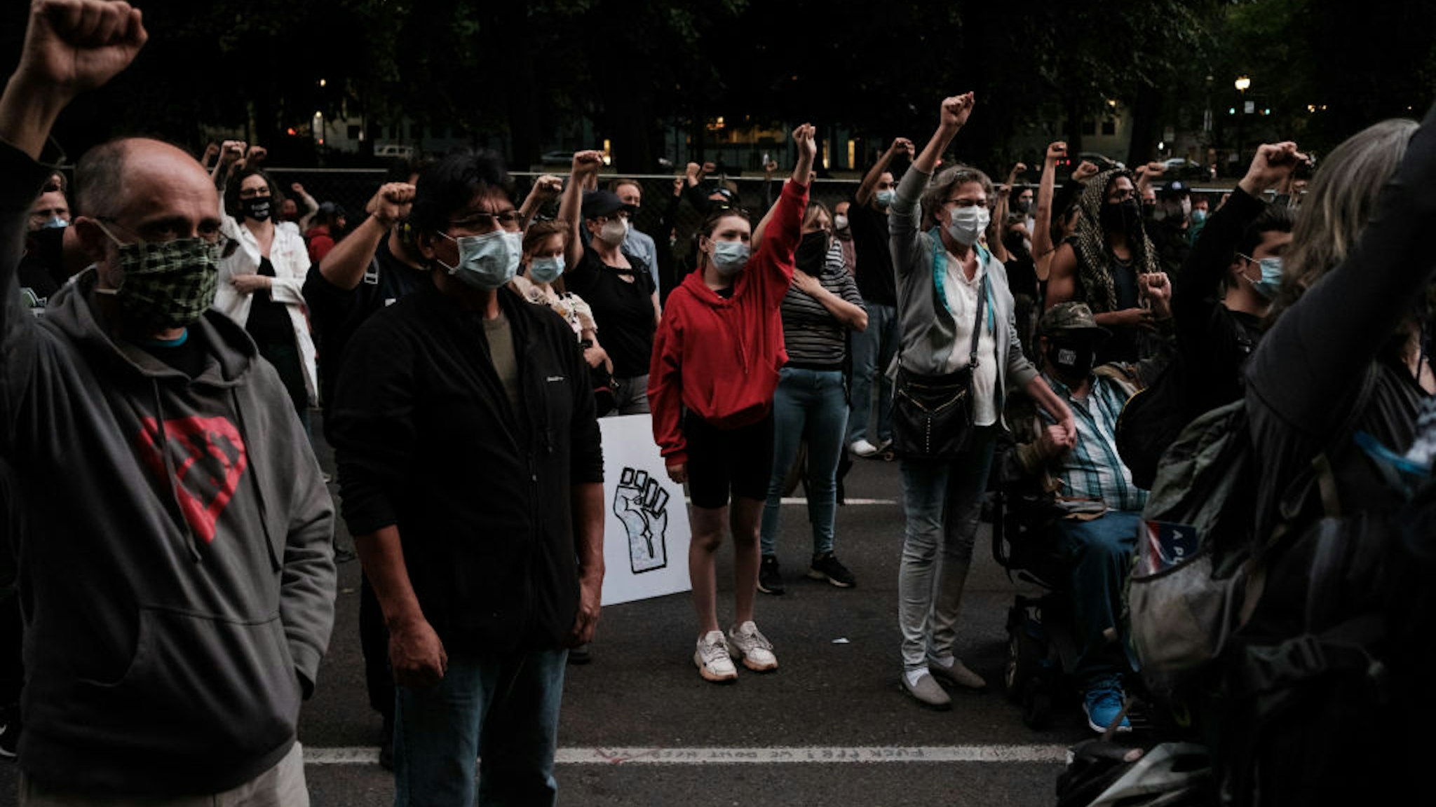 Protestors raise their hands up in solidarity after Portland Commissioner Jo Ann Hardesty speaks to the crowd Portlanders' rights to free speech and assembly at Multnomah County Justice Center on July 17, 2020 in Portland, Oregon.
