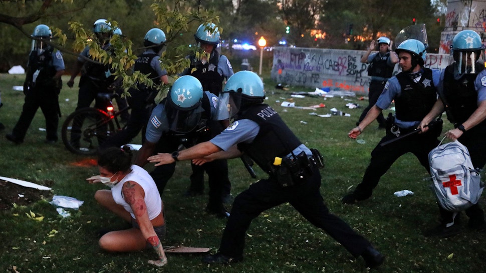 A protester and Chicago police clash after protesters tried to topple the Christopher Columbus statue in Grant Park during a rally on July 17, 2020. (Chris Sweda/Chicago Tribune/Tribune News Service via Getty Images)
