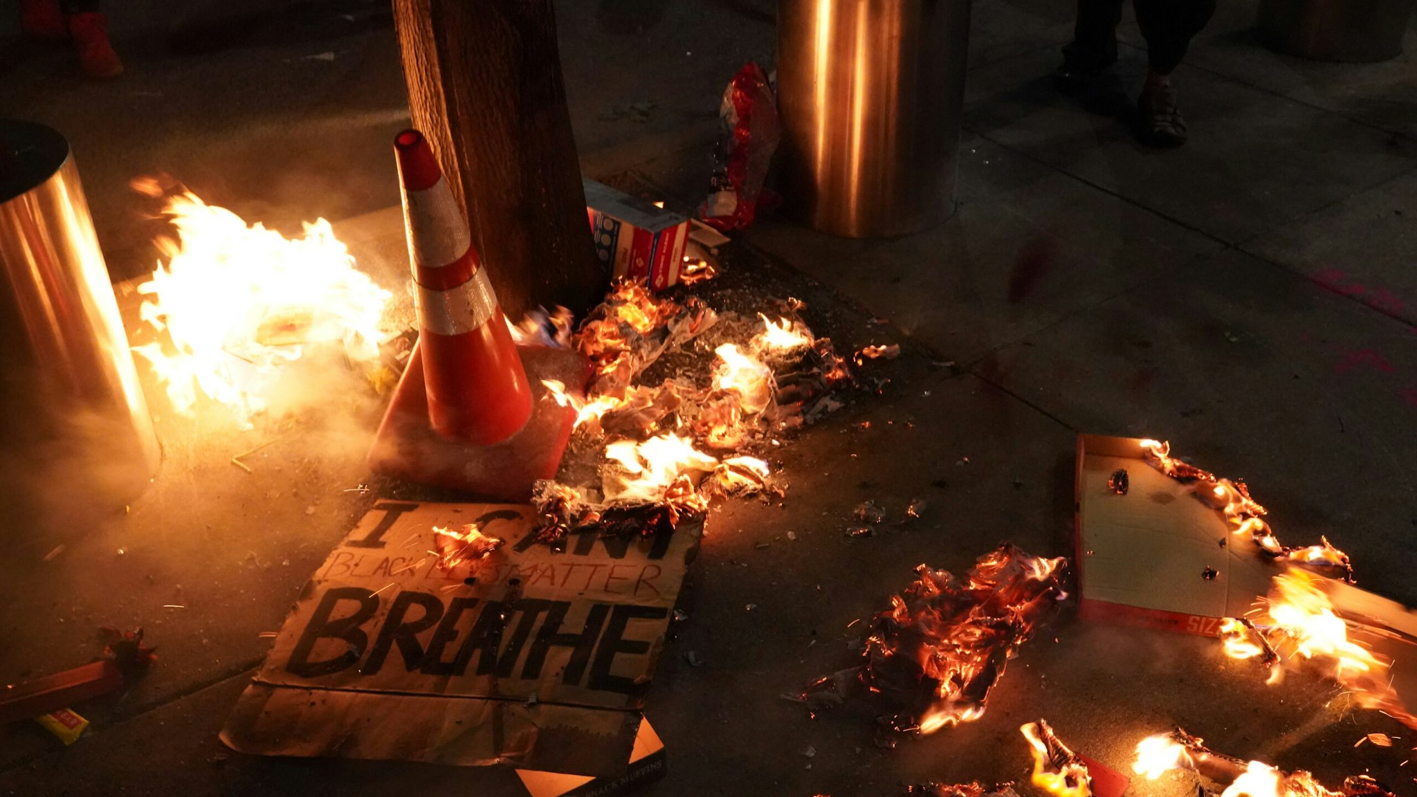 PORTLAND, OR - JULY 20: A fire burns around a sign reading I cant breathe during a protest in front of the Mark O. Hatfield U.S. Courthouse on July 201, 2020 in Portland, Oregon. Monday night marked 54 days of protests in Portland following the death of George Floyd in police custody. (Photo by Nathan Howard/Getty Images)