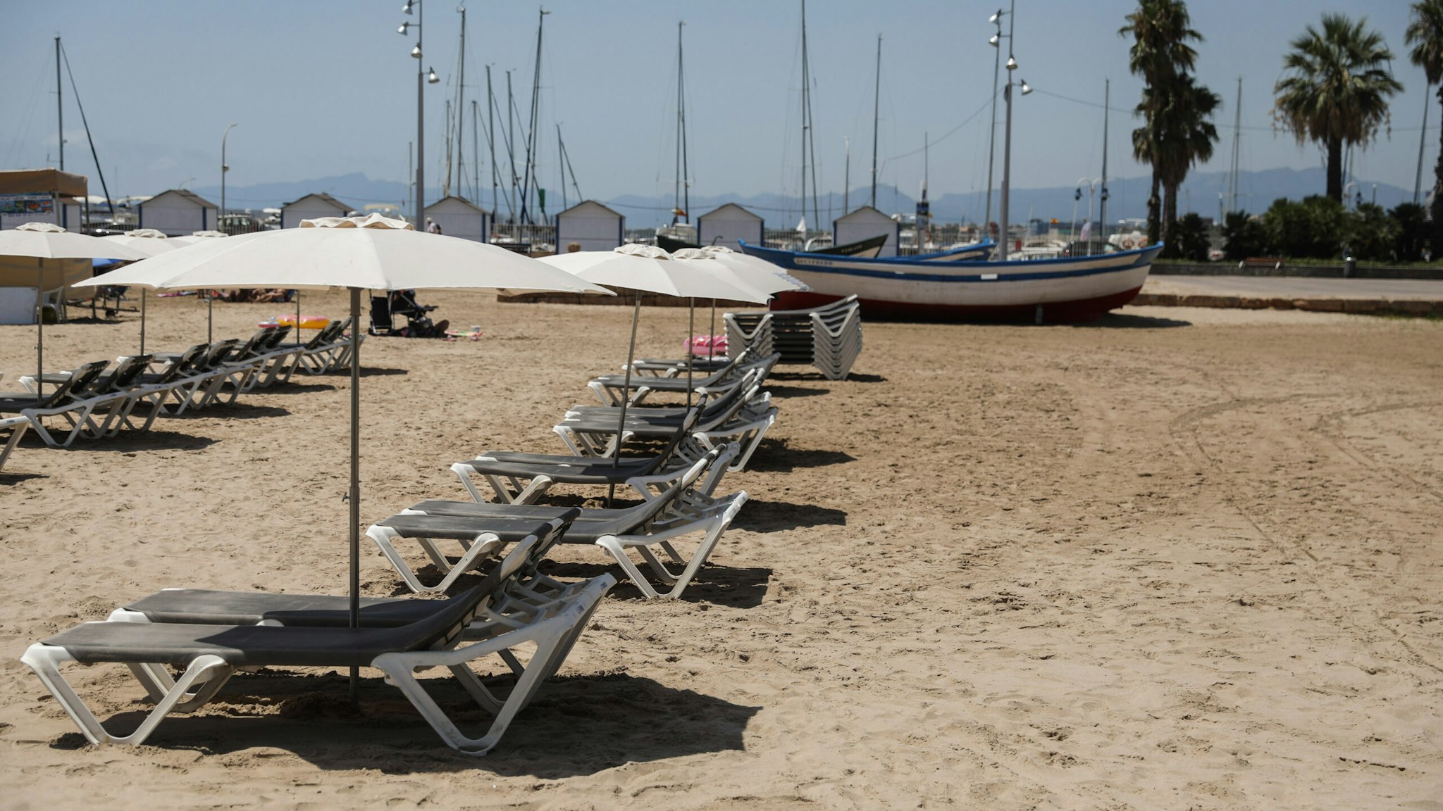 Empty sun loungers sit on the sand at the beach in Salou, Spain, on Monday, July 27, 2020. Spain's tourism industry is at increasing risk of being shut down as countries across Europe seek to restrict visits to the Mediterranean nation, following an order by the British government to quarantine visitors. Photographer: Angel Garcia/Bloomberg via Getty Images