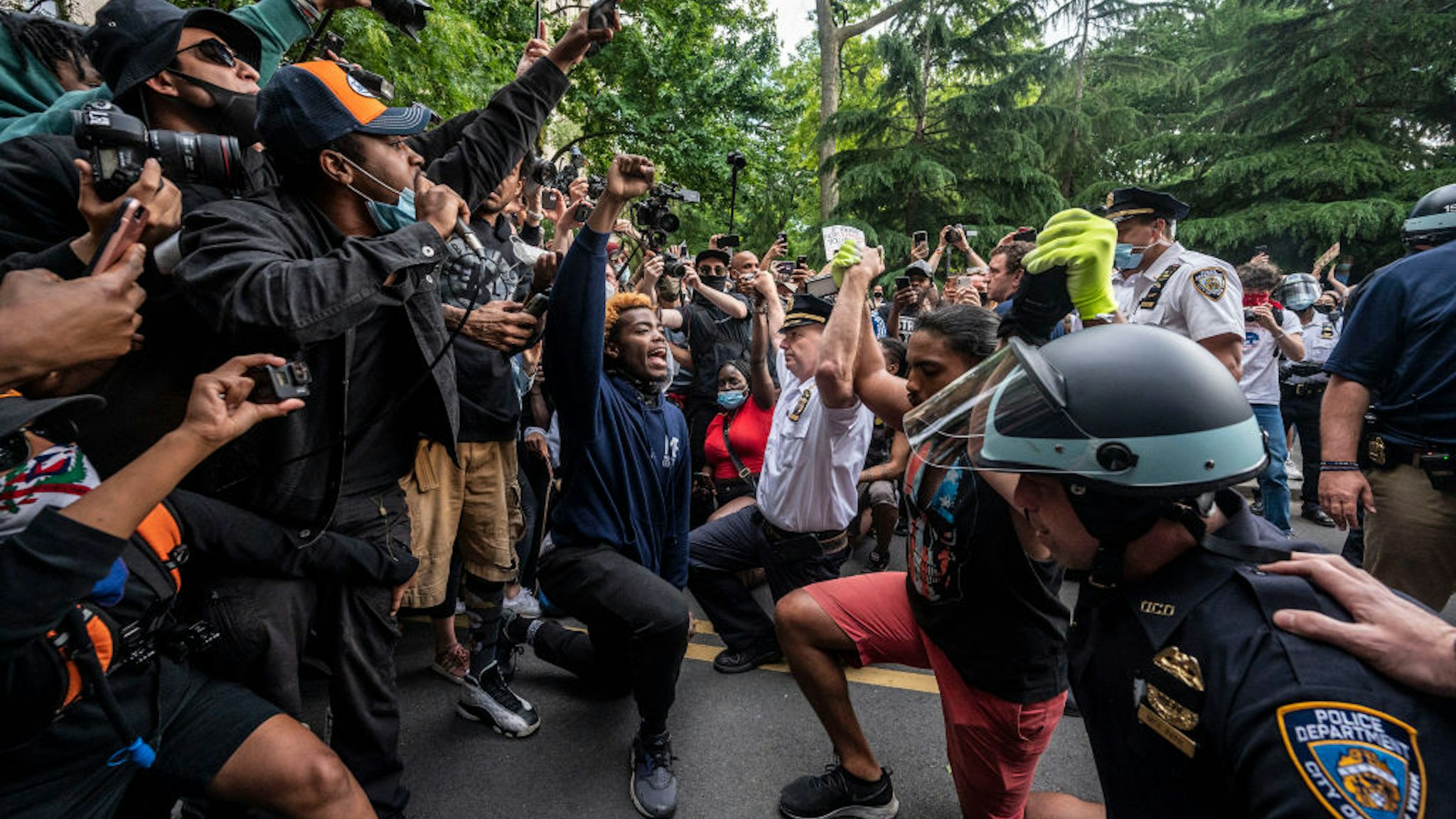 New York, N.Y.: Chief of Department of the New York City Police, Terence Monahan, takes a knee with activists as protesters paused while walking in Manhattan on June 1, 2020.
