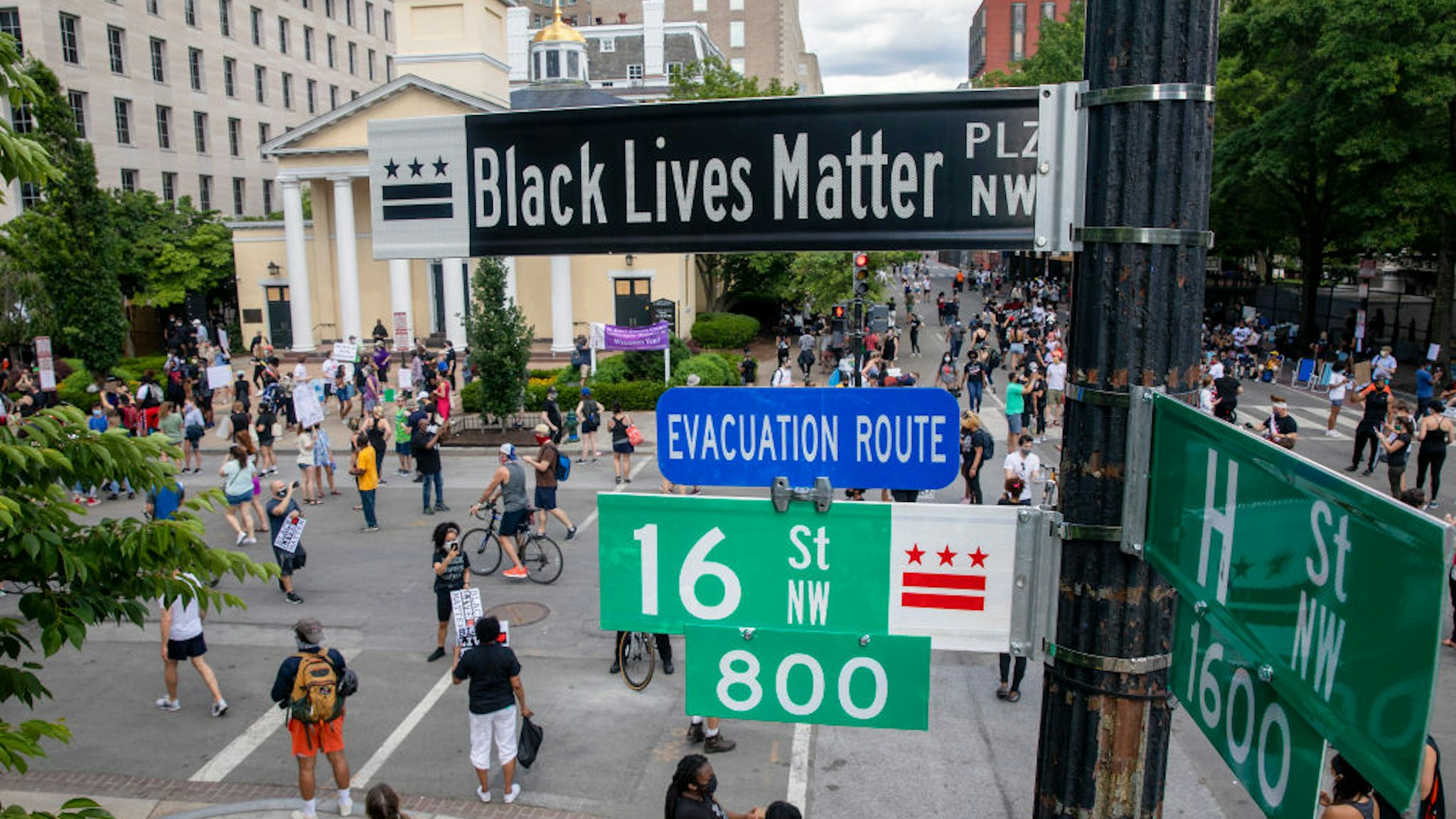 People walk near 16th and H street after volunteers, with permission from the city, painted "Black Lives Matter" on the street near the White House on June 05, 2020 in Washington, DC.
