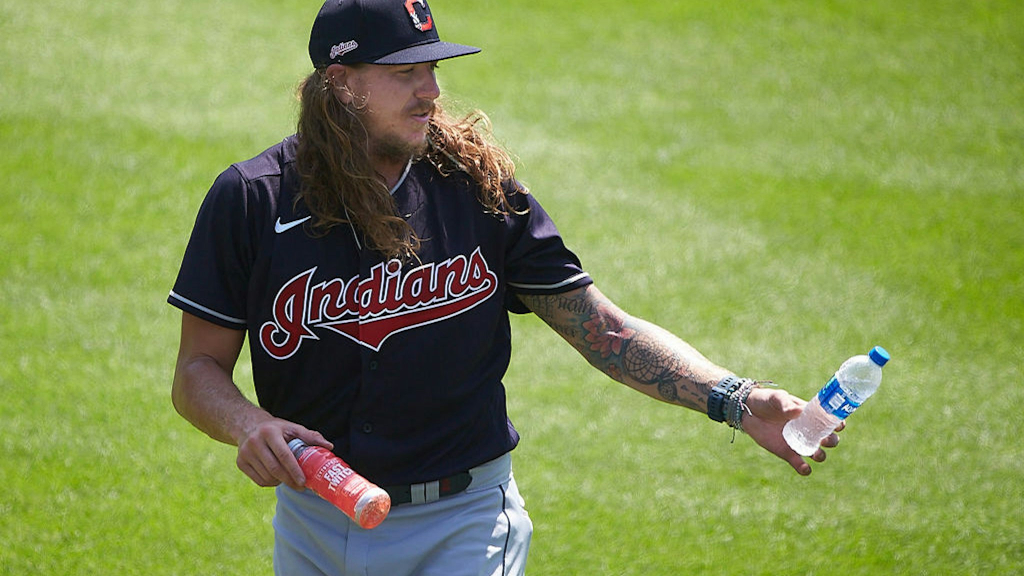 In this handout image provided by the Cleveland Indians, Mike Clevinger #52 of the Cleveland Indians walks on the field during a summer workout in preparation for a shortened MLB season due to the coronavirus (COVID-19) pandemic at Progressive Field on July 03, 2020 in Cleveland, Ohio.