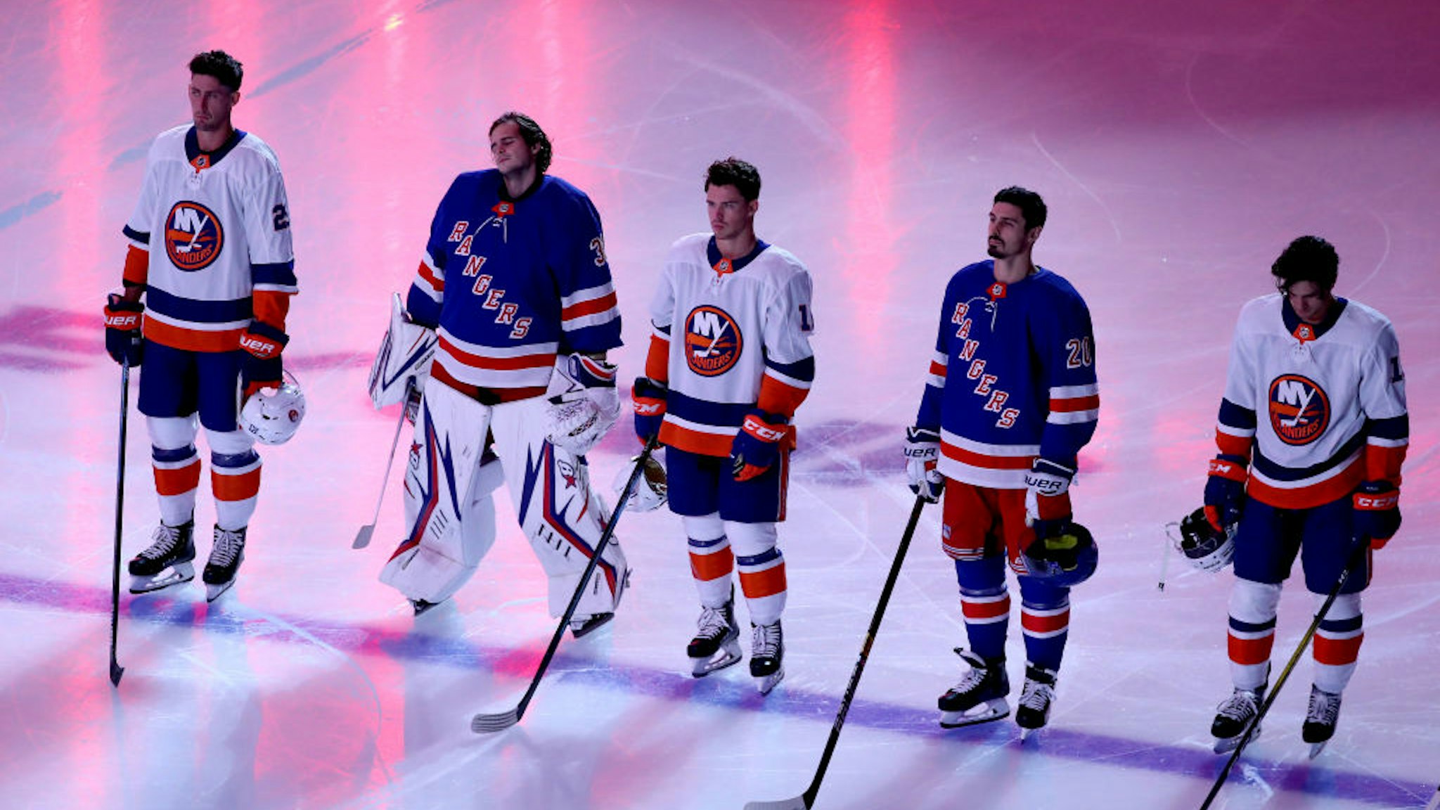 The New York Islanders and the New York Rangers stand together as the Canadian and American national anthems are played before the start of an exhibition game prior to the 2020 NHL Stanley Cup Playoffs at Scotiabank Arena on July 29, 2020 in Toronto, Ontario.