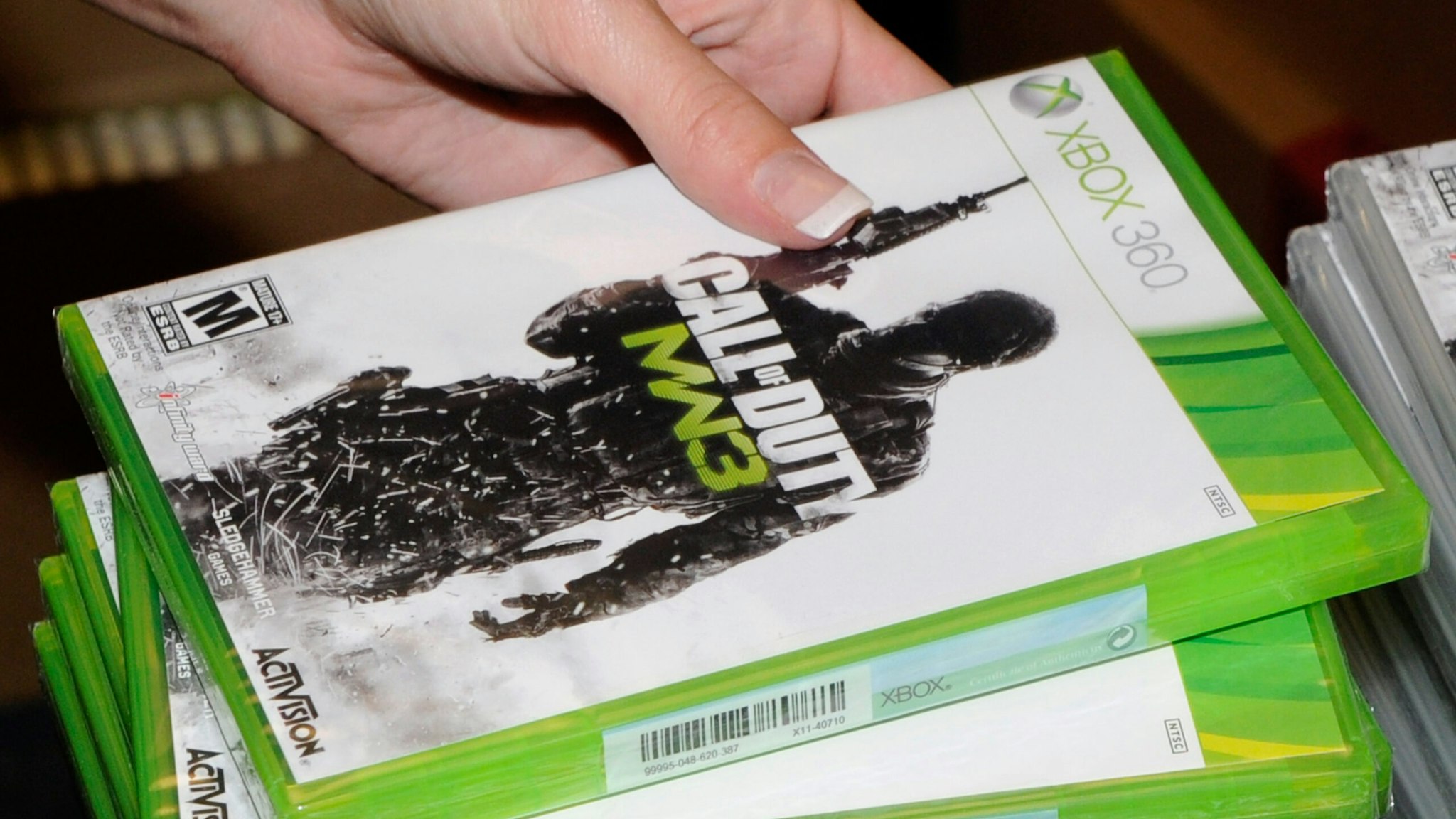 NORTH LAS VEGAS, NV - NOVEMBER 08: GameStop employee Randi Taber rings up copies of "Call of Duty: Modern Warfare 3" for the Xbox 360 during a launch event for the highly anticipated video game at a GameStop Corp. store November 8, 2011 in North Las Vegas, Nevada. Video game publisher Activision released the eighth installment in the "Call of Duty" franchise at midnight. (Photo by Ethan Miller/Getty Images)