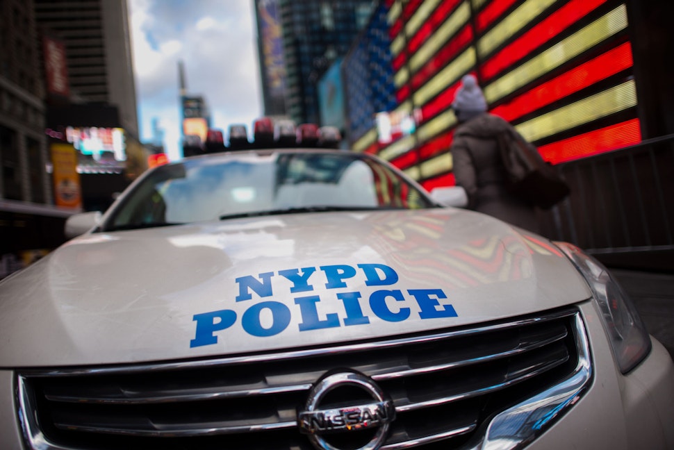 A pedestrians walks past a New York Police Department (NYPD) cruiser on patrol in the Times Square area of New York, U.S., on Monday, Jan. 5, 2015. The New York City Police Department redeployed officers in response to an attack at the Paris offices of a French weekly magazine, in what has become a regular step for the largest U.S. city following terrorist attacks in other parts of the world. Photographer: Craig Warga/Bloomberg via Getty Images