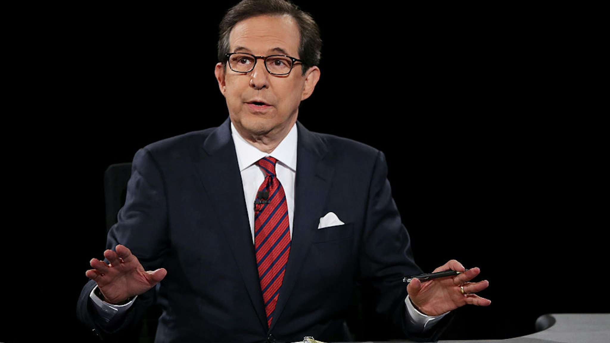 Fox News anchor and moderator Chris Wallace asks the candidates a question during the third U.S. presidential debate at the Thomas &amp; Mack Center on October 19, 2016 in Las Vegas, Nevada.