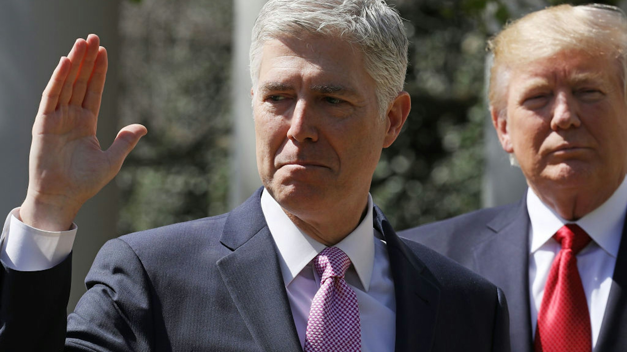 U.S. Supreme Court Associate Justice Judge Neil Gorsuch takes the judicial oath as President Donald Trump looks on during a ceremony in the Rose Garden at the White House April 10, 2017 in Washington, DC.