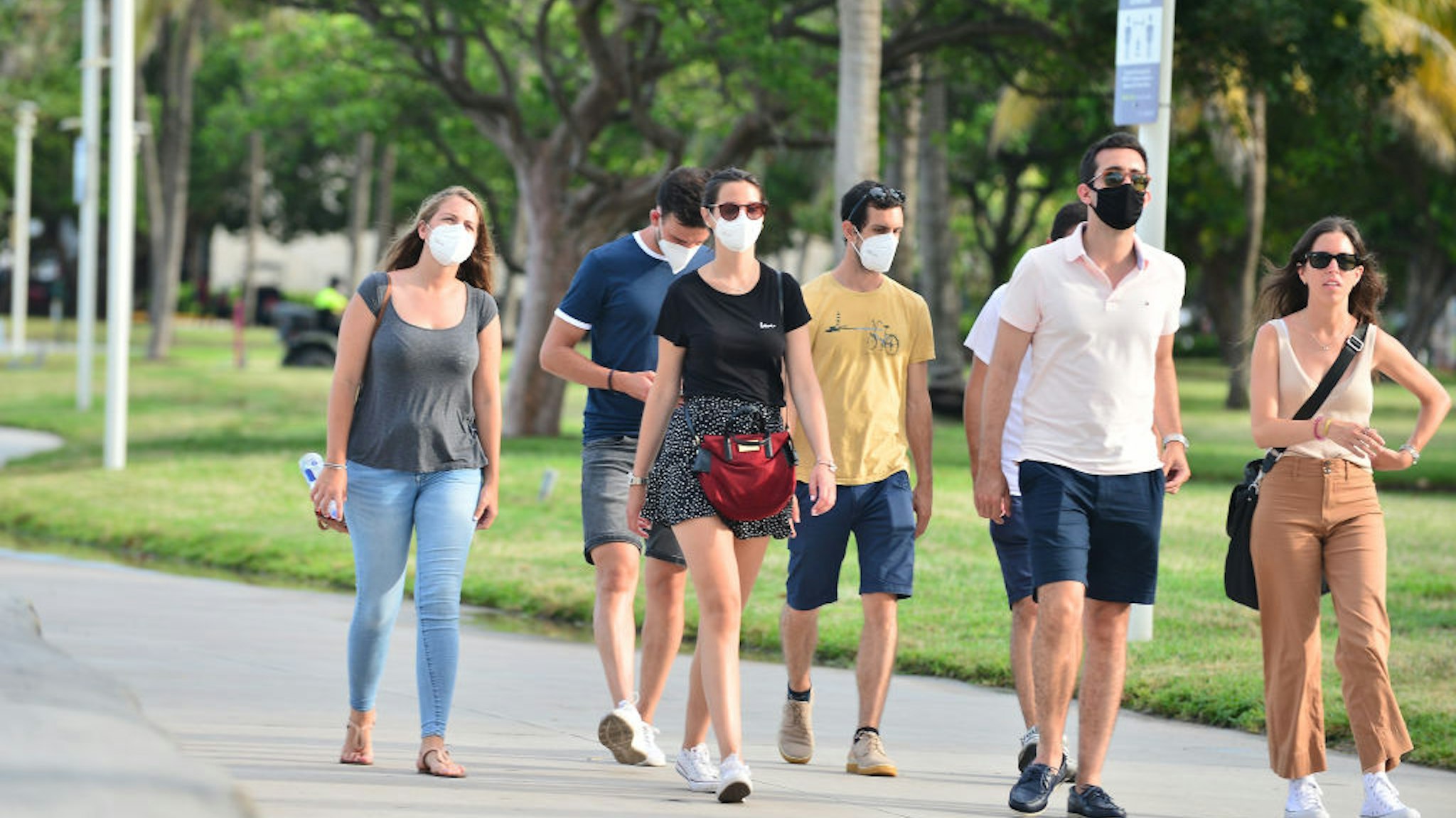 MIAMI BEACH, FL - JULY 06: People seen walking on the beach side walk some wearing mask and some not wearing a face mask on July 06, 2020 in Miami Beach, Florida. Miami Beach has mandated that masks be worn in public, where social distancing is not possible. With a surge in COVID-19 cases, Mayor Carlos Gimenez on Monday has ordered the closing of all restaurants, gyms and fitness centers, ballrooms and short-term vacation rentals. Mayor Gimenez will allow beaches to re-open on July 7th after being closed over the 4th of July weekend. (Photo by Johnny Louis/Getty Images)