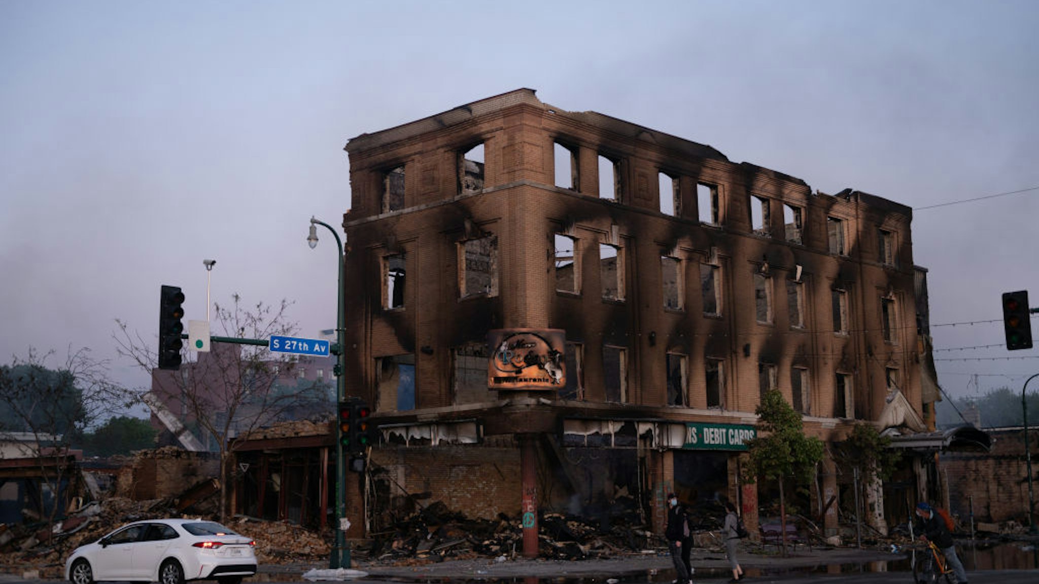 The shell of a building that was burnt during the earlier fires sits still smoldering in Minneapolis, United States, on May 29, 2020. Protests continued following the death of George Floyd, who died after being restrained by Minneapolis police officers on Memorial Day. (Photo by Zach D Roberts/NurPhoto via Getty Images)