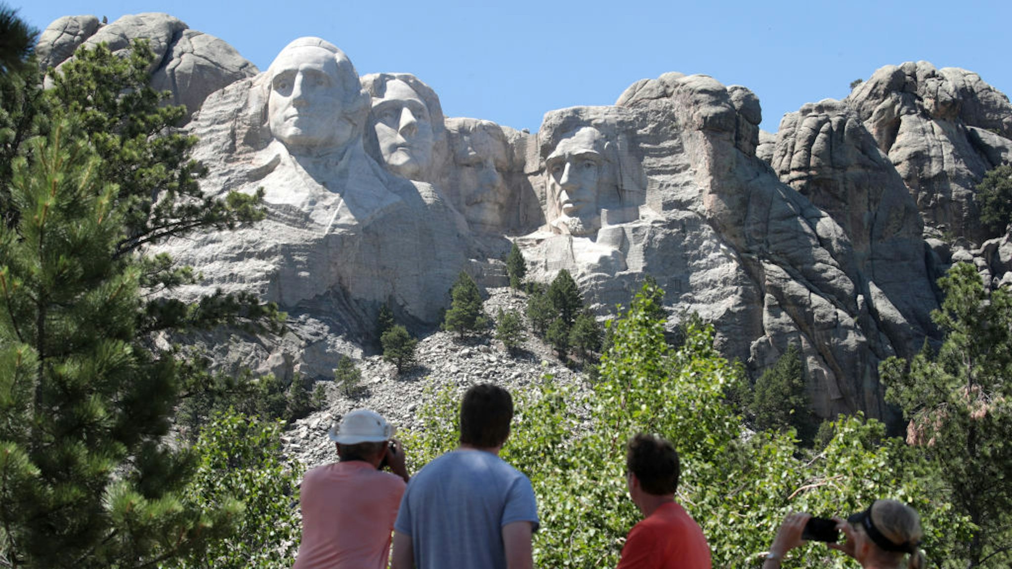 Tourists visit Mount Rushmore National Monument on July 01, 2020 in Keystone, South Dakota. President Donald Trump is expected to visit the monument and make remarks before the start of a fireworks display on July 3. (Photo by Scott Olson/Getty Images)