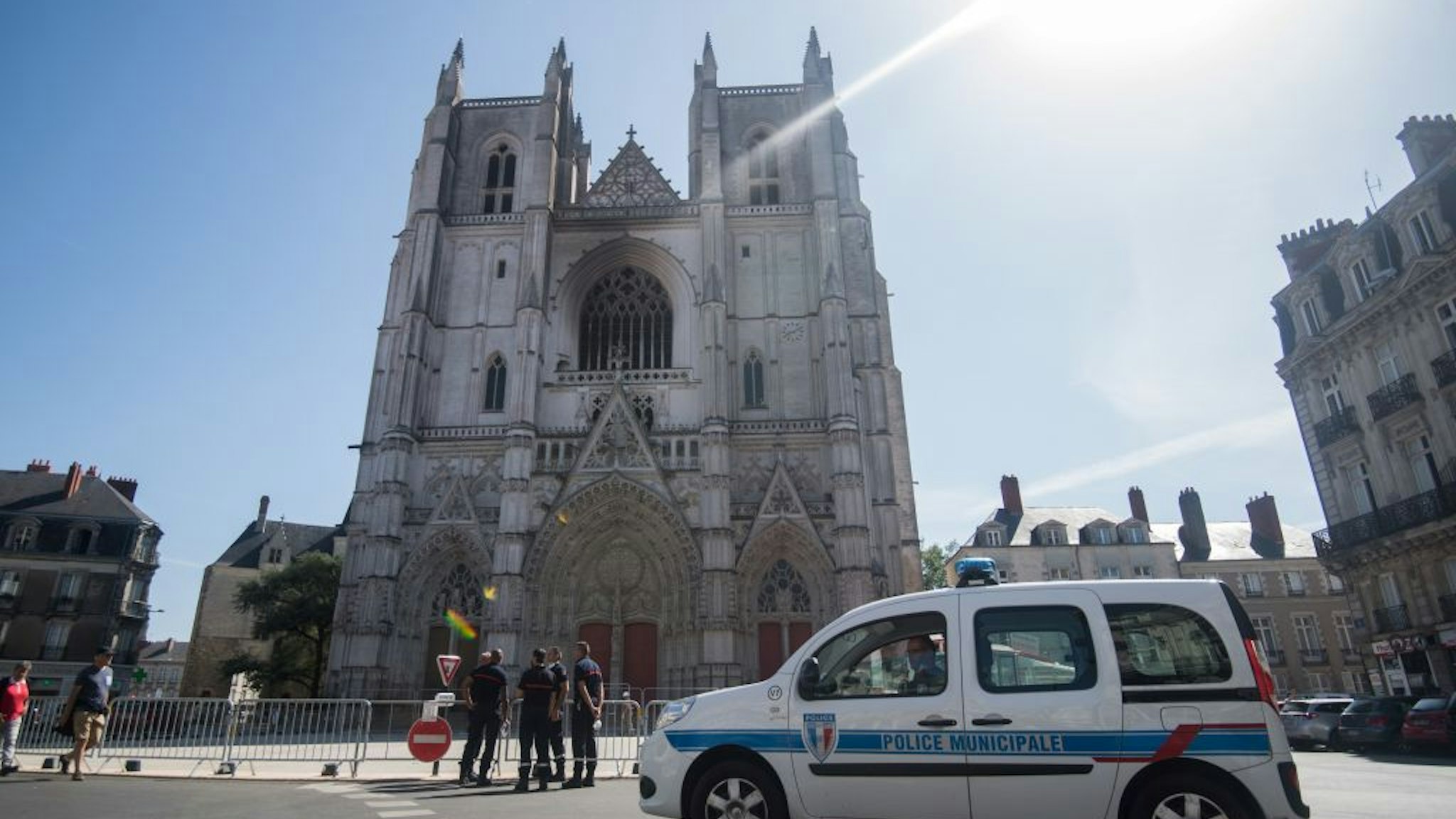 Firefighters stand in front of Saint-Pierre-et-Saint-Paul cathedral in Nantes, western France, on July 20, 2020, two days after a fire broke out in three places at the gothic cathedral of Nantes in western France, destroying stained glass windows and the grand organ and sparking an arson investigation. (Photo by Loic VENANCE / AFP) (Photo by LOIC VENANCE/AFP via Getty Images)