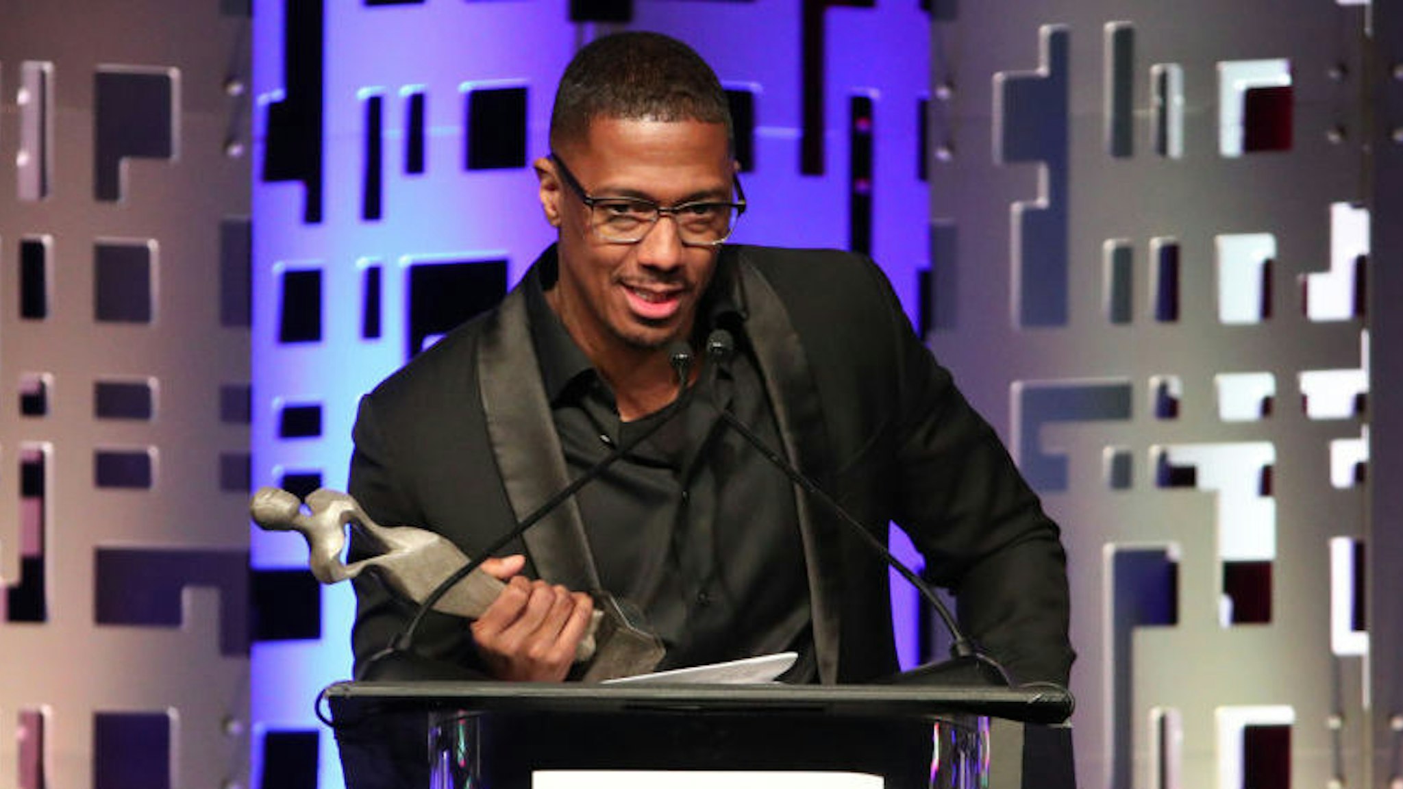 Host Nick Cannon accepts the Anne Douglas Award on behalf of Kevin and Eniko Hart onstage at The Los Angeles Mission Legacy Of Vision Gala at The Beverly Hilton Hotel on October 24, 2019 in Beverly Hills, California. (Photo by Rich Fury/Getty Images)