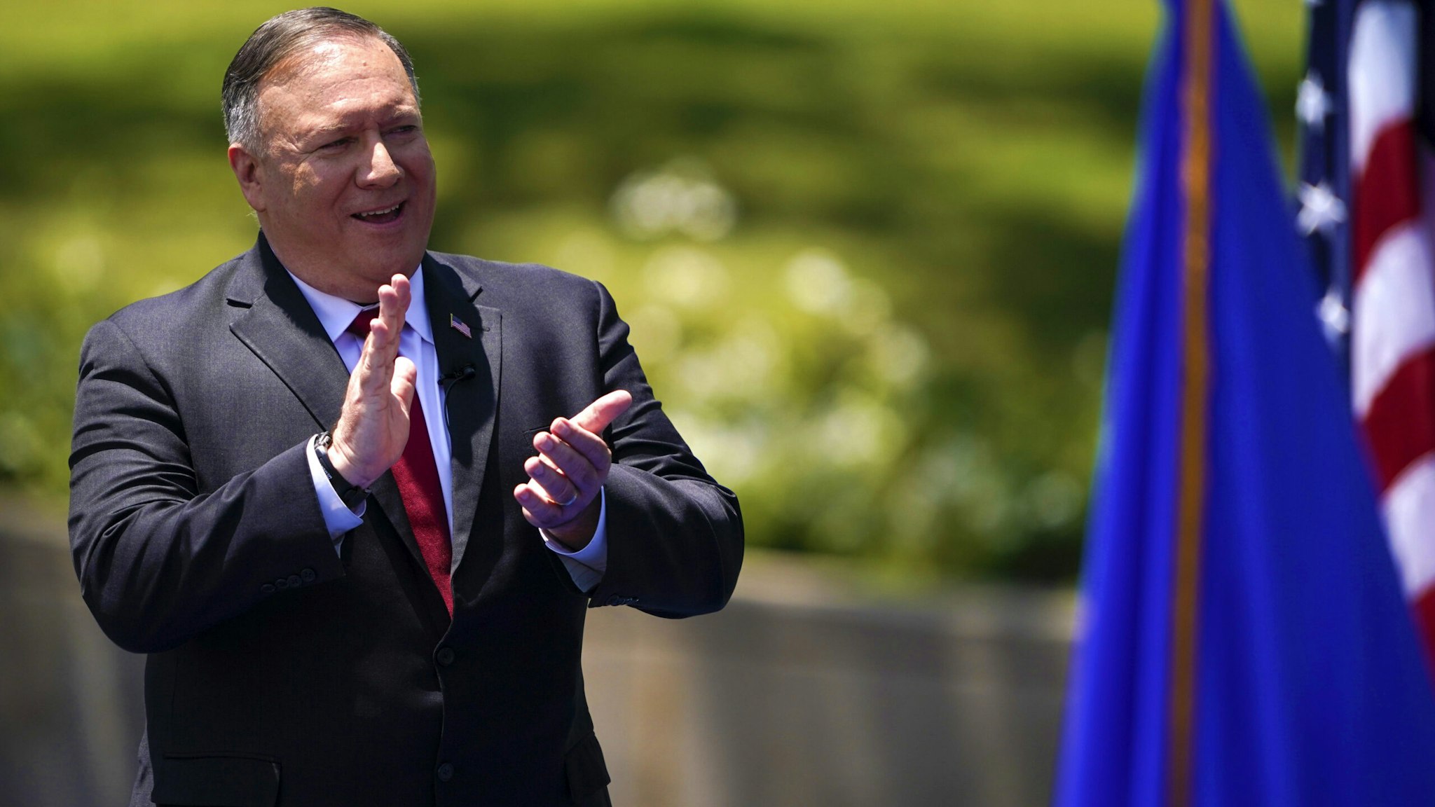 US Secretary of State Mike Pompeo claps as he speaks at the Richard Nixon Presidential Library, July 23, 2020, in Yorba Linda, California.