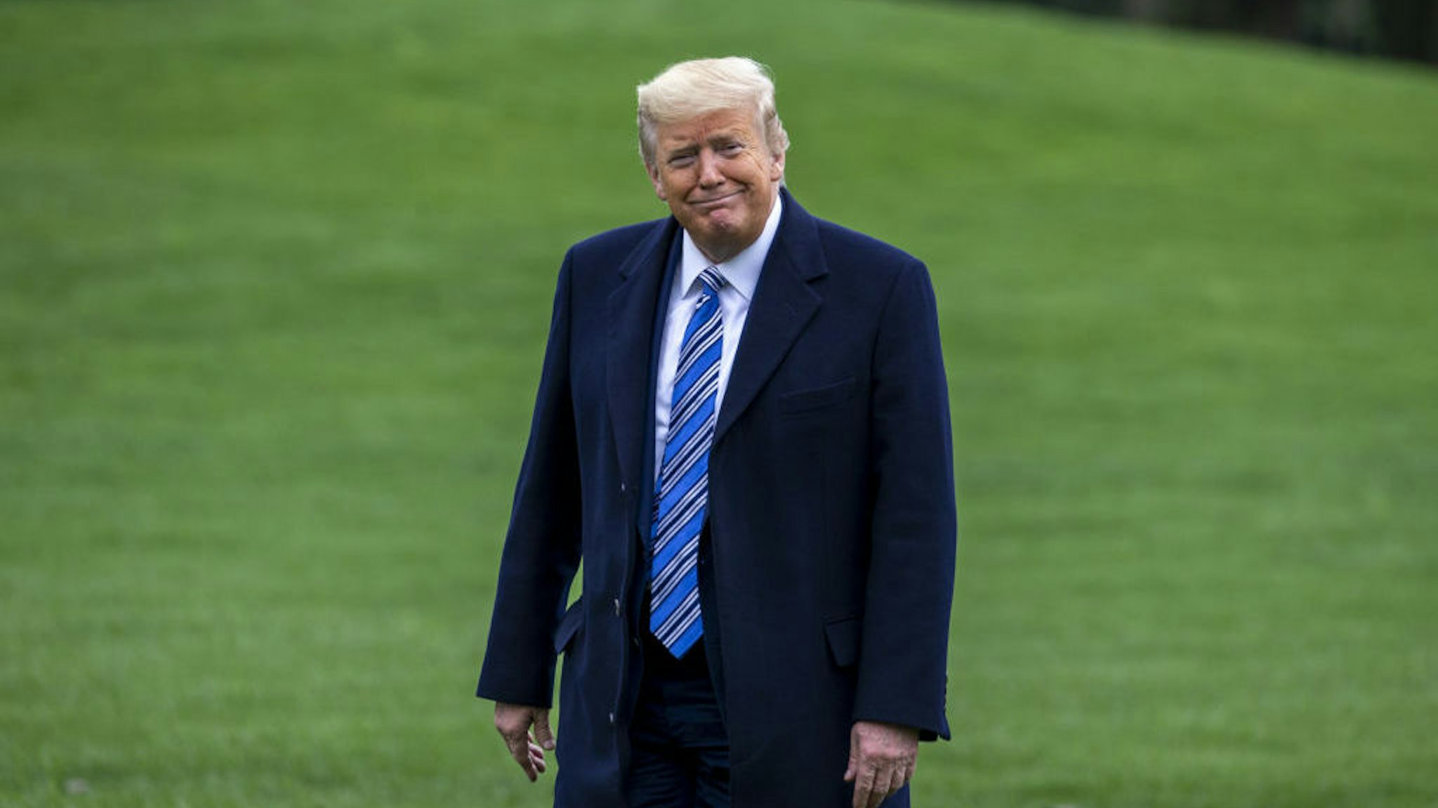 U.S. President Donald Trump smiles while walking on the South Lawn of the White House in Washington, D.C., U.S., on Saturday, March 28, 2020. Trump said he's considering an enforced quarantine for parts of New York, New Jersey and Connecticut to curb the coronavirus outbreak -- a move that could fall afoul of the U.S. Constitution. Photographer: Tasos Katopodis/Bloomberg