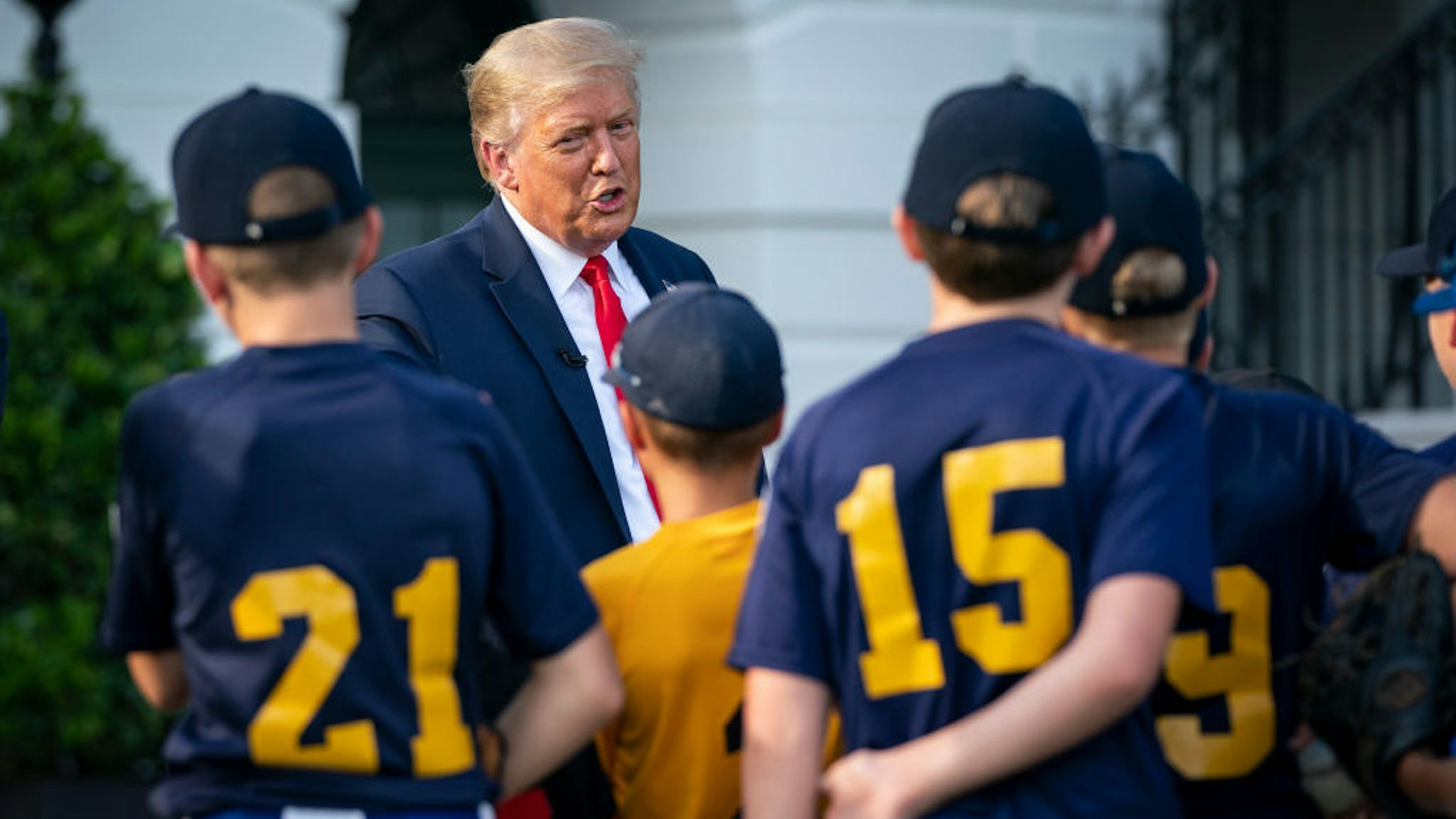 WASHINGTON, DC - JULY 23: U.S. President Donald Trump talks with youth baseball players on the South Lawn of the White House on July 23, 2020 in Washington, DC. President Trump and former New York Yankees Hall of Fame pitcher Mariano Rivera met with youth baseball players to celebrate Opening Day of Major League Baseball. (Photo by Drew Angerer/Getty Images)