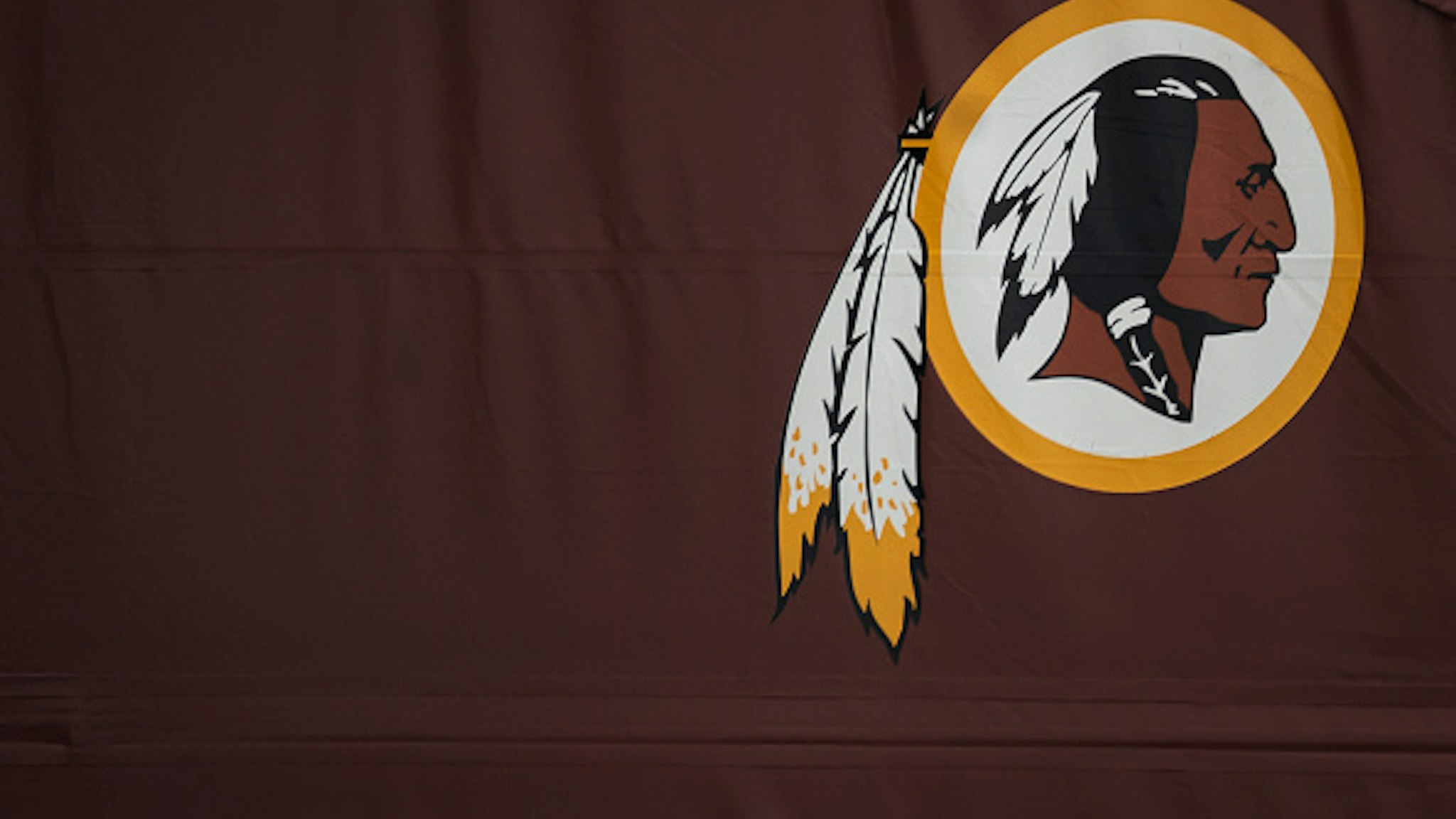 LANDOVER, MD - JULY 07: A Washington Redskins logo is seen on the outside of FedEx Field on July 7, 2020 in Landover, Maryland. After receiving recent pressure from sponsors and retailers, the NFL franchise is considering a name change to replace Redskins. The term "redskin" is a dictionary-defined racial slur for Native Americans.