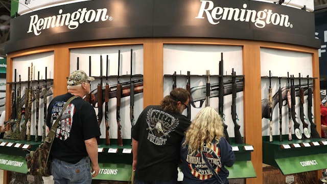DALLAS, TX - MAY 05: Attendees look at a display of Remington shotguns during the NRA Annual Meeting & Exhibits at the Kay Bailey Hutchison Convention Center on May 5, 2018 in Dallas, Texas. The National Rifle Association's annual meeting and exhibit runs through Sunday. (Photo by Justin Sullivan/Getty Images)
