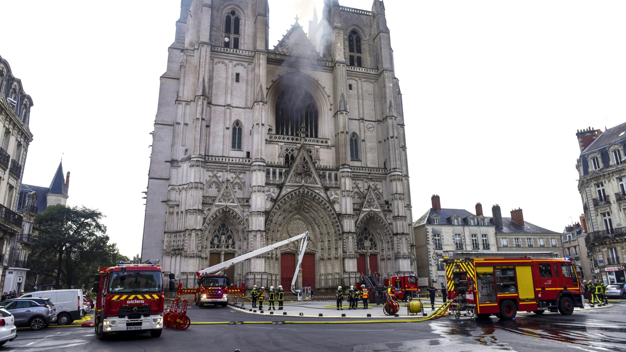 Firefighters are at work to put out a fire at the Saint-Pierre-et-Saint-Paul cathedral in Nantes, western France, on July 18, 2020. - A blaze that broke inside the gothic cathedral of Nantes on July 18 has been contained, emergency officials said, adding that the damage was not comparable to last year's fire at Notre-Dame cathedral in Paris. "The damage is concentrated on the organ, which seems to be completely destroyed. Its platform is very unstable and could collapse," regional fire chief General Laurent Ferlay told a press briefing in front of the cathedral.