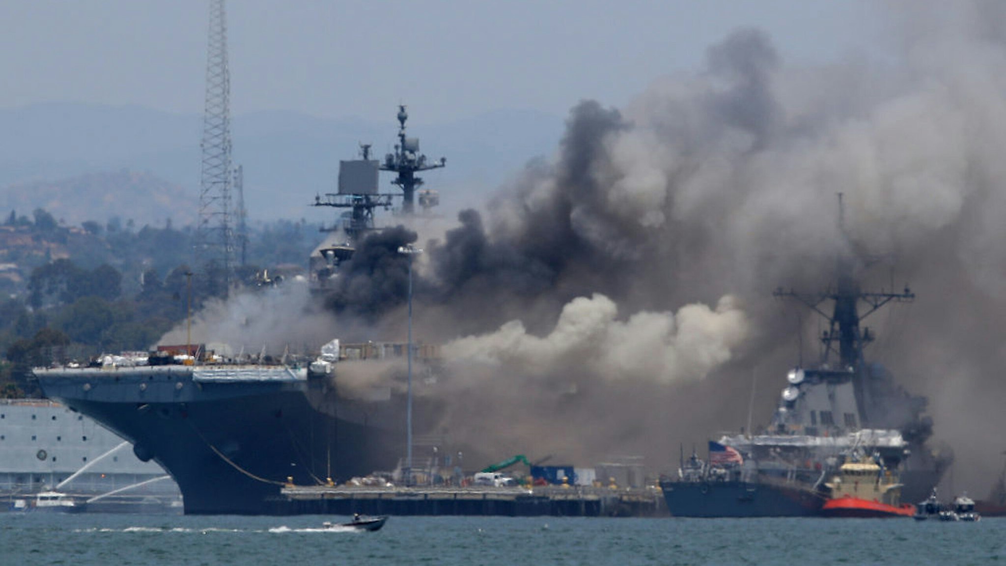 SAN DIEGO, CALIFORNIA - JULY 12: A fire burns on the amphibious assault ship USS Bonhomme Richard at Naval Base San Diego on July 12, 2020 in San Diego, California. There was an explosion on board the ship with multiple injuries reported.