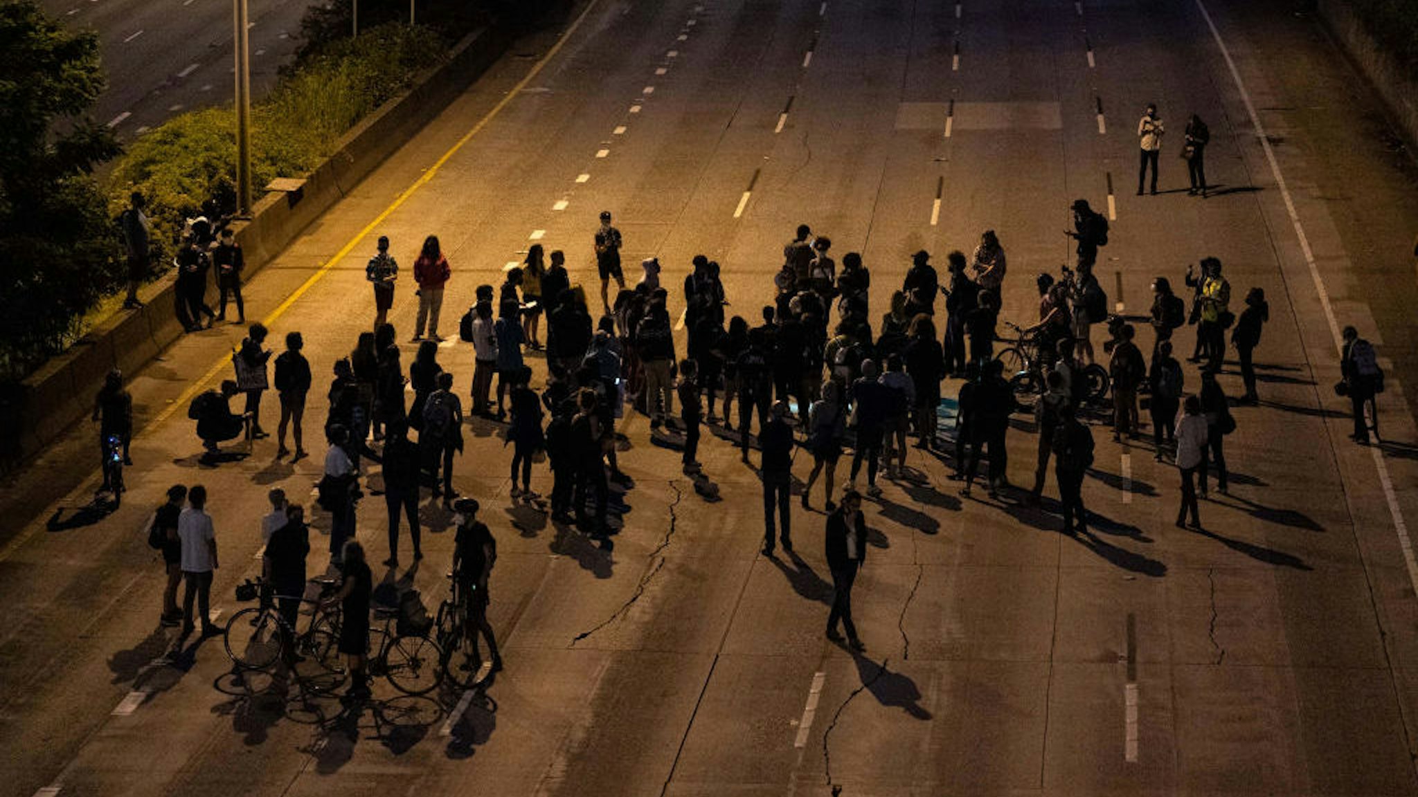 Protesters gather on Interstate 5 after marching there from the area known as the Capitol Hill Organized Protest (CHOP) on June 23, 2020 in Seattle, Washington. On Monday, Seattle Mayor Jenny Durkan said that the city would phase down the CHOP zone and that the Seattle Police Department would return to its vacated East Precinct. (Photo by David Ryder/Getty Images)