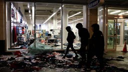 Seattle Riot Old Navy People walk past a store thats been looted during a riot following a peaceful rally expressing outrage over the death of George Floyd on May 30, 2020 in Seattle, Washington. Protests have erupted nationwide after Floyd died while in the custody of police in Minneapolis. (Photo by Karen Ducey/Getty Images)