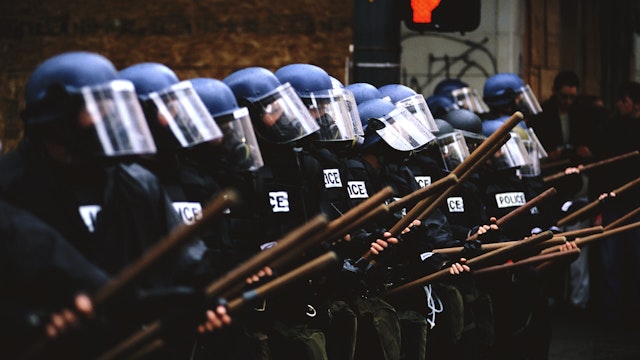 Members of the Seattle Police in riot gear line up to face protesters during the World Trade Organization's (WTO) 1999 conference in Seattle. What started out as a peaceful protest turned into a violent clash between demonstrators and riot police, with many injuries, over 500 arrests, and major damage to the downtown area.