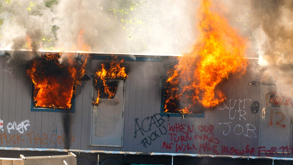 SEATTLE, WA - JULY 25: A trailer on a construction site for a youth detention center burns after protesters targeted the site during protests in Seattle on July 25, 2020 in Seattle, Washington. Police and demonstrators clash as protests continue in the city following reports that federal agents may have been sent to the city.