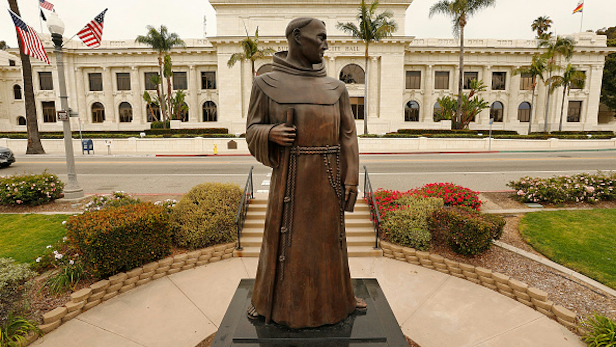VENTURA, CA - JUNE 24: The bronze statue of Father Junipero Serra who founded nine Spanish missions in California including Mission San Buenaventura stands in front of Ventura City Hall. A joint statement was issued from local political, indigenous and Catholic leaders pledging to remove the monument, originally commissioned in the 1930s but replaced in 1989. The time has come for the statue to be taken down and moved to a more appropriate nonpublic location, read the statement, issued by Ventura Mayor Matt LaVere. After a protest last weekend Ventura city spokeswoman Heather Sumagaysay said the city is making plans to host community discussions regarding the Serra statue and there is no timeline for its removal, she said. It is our priority to be receptive to public concerns and provide an environment where all voices are heard and respected. A historic decision such as this will involve the voices of the Chumash tribe, the City Council and the residents of Ventura, Sumagaysay said in an emailed statement. The city remains committed to collaborating with the community to determine next steps. We will inform the public of opportunities to participate and offer input at a future meeting. The move comes after a Father Serra statue was toppled last weekend on Olvera St. in downtown Los Angeles and people were considering changing the name of Ft Bragg, but voted the change down. Ventura City Hall on Wednesday, June 24, 2020 in Ventura, CA.